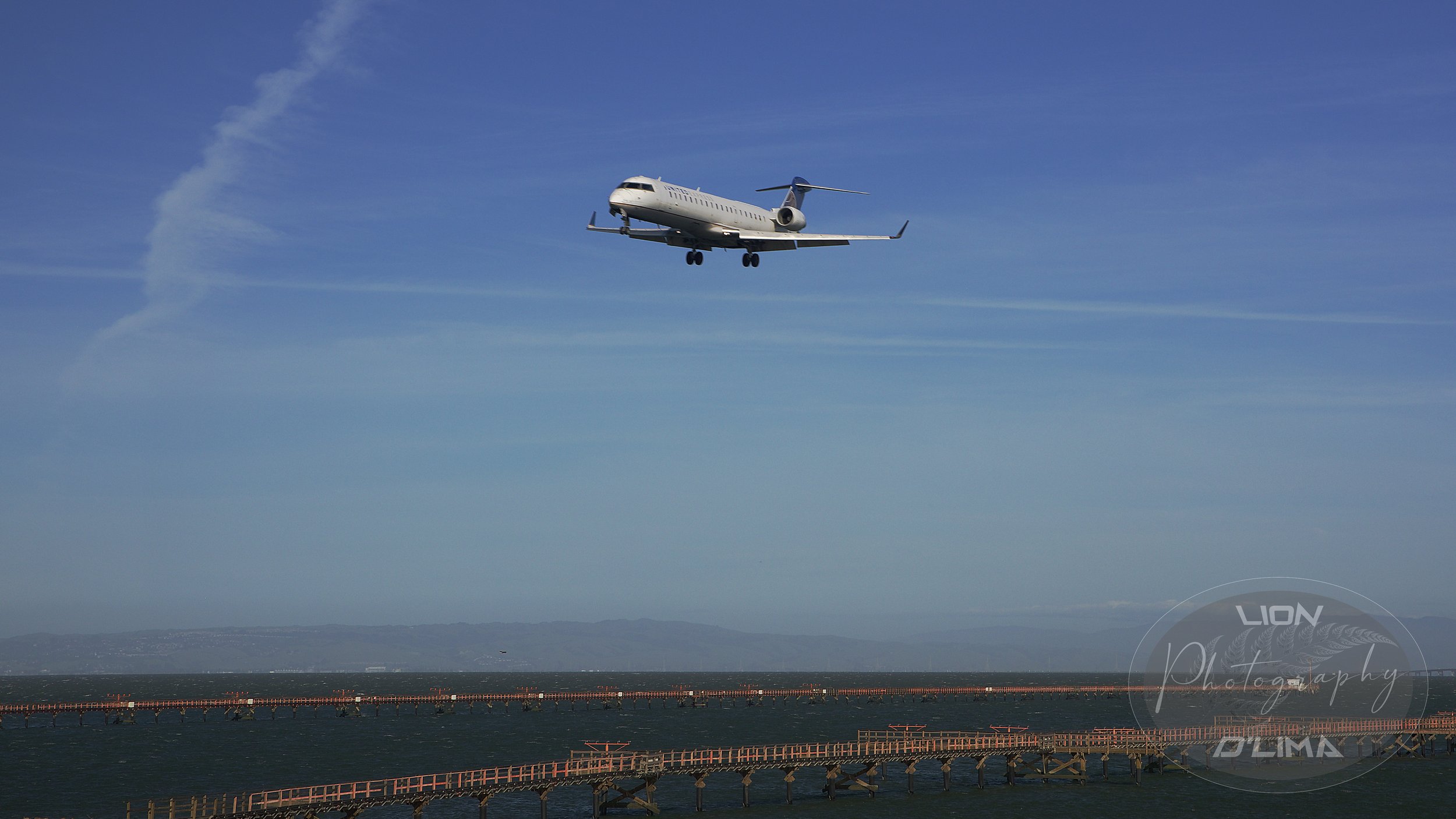 United CRJ-550 on short final into San Francisco International Airport Runway 28L