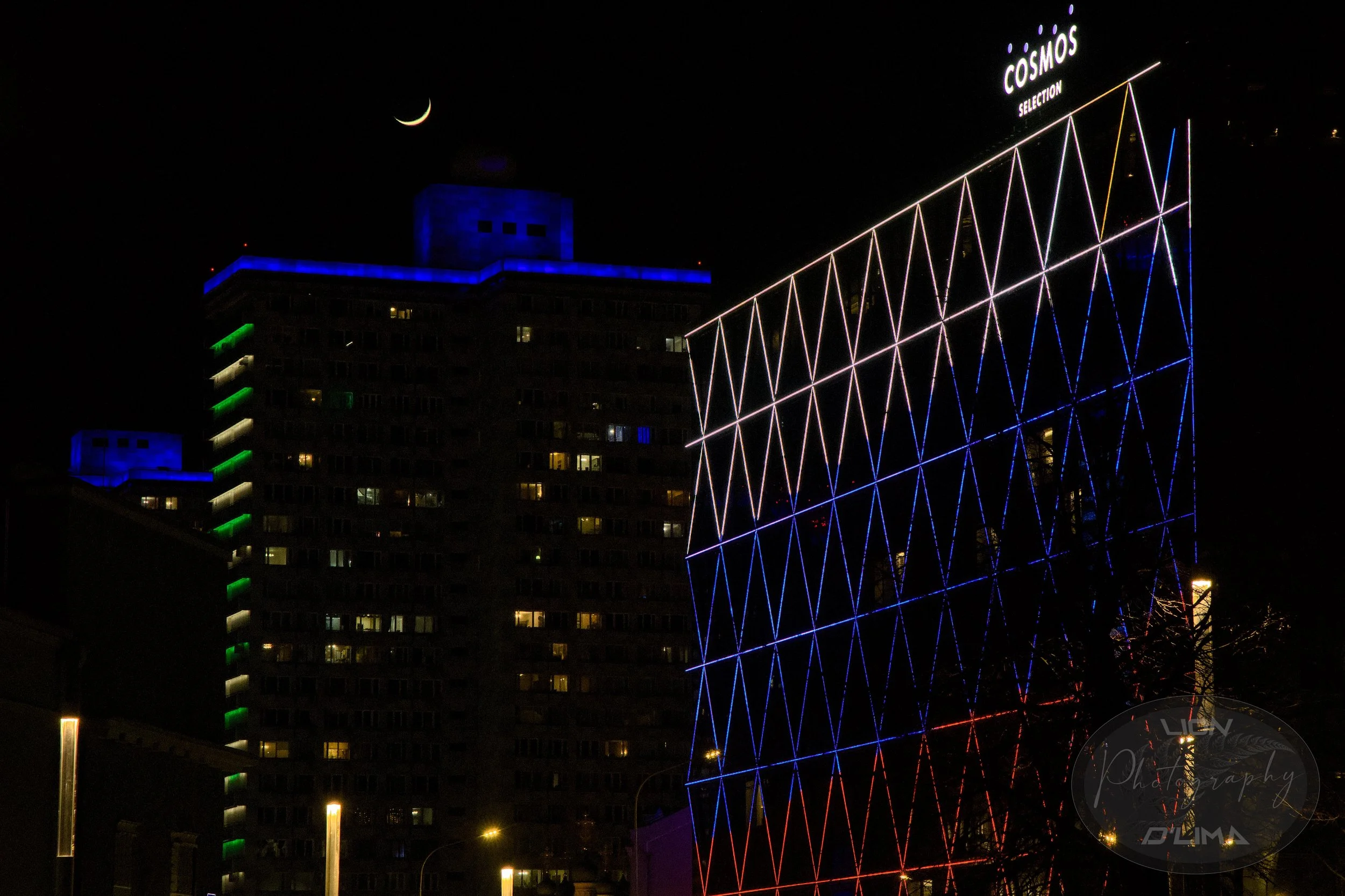 Cosmos Building showing the Russian flag colours in Moscow under a crescent moon