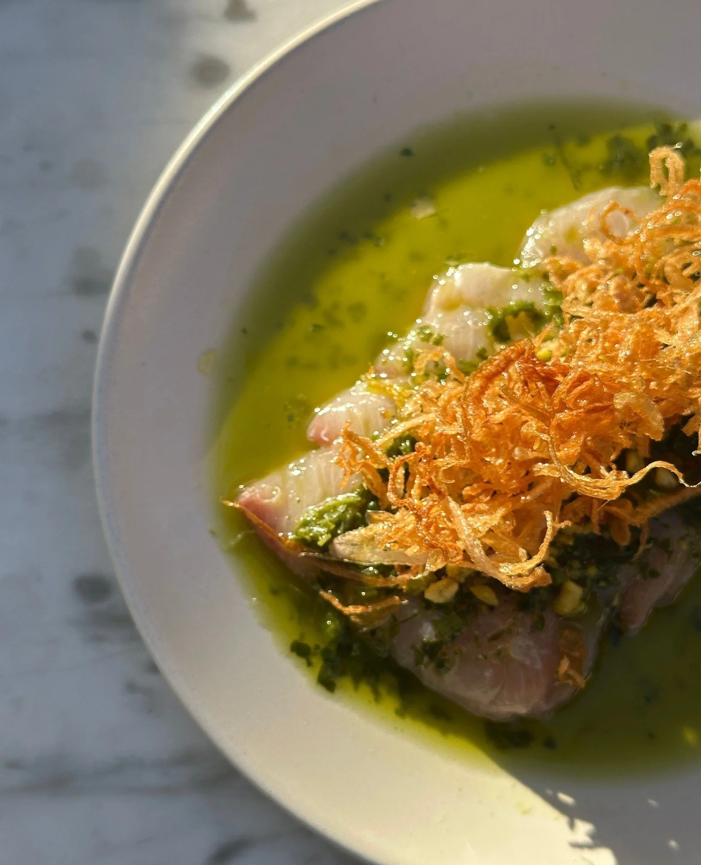 Hamachi Crudo topped with pistachio salsa verde, fried shallots, and calamansi vinegar. This is the kind of appetizer that gets you excited for the rest of the meal!⁠
⁠