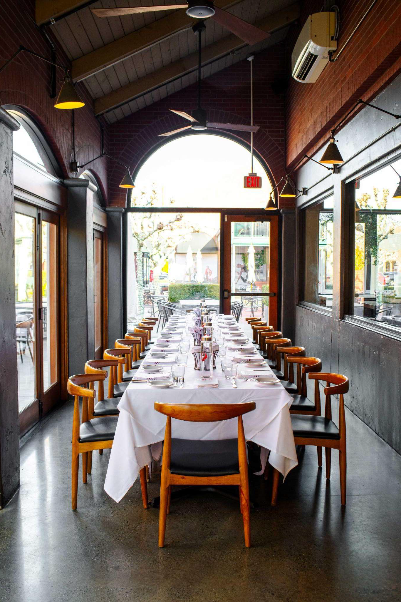 the atrium room with a large long table set up and bright windows