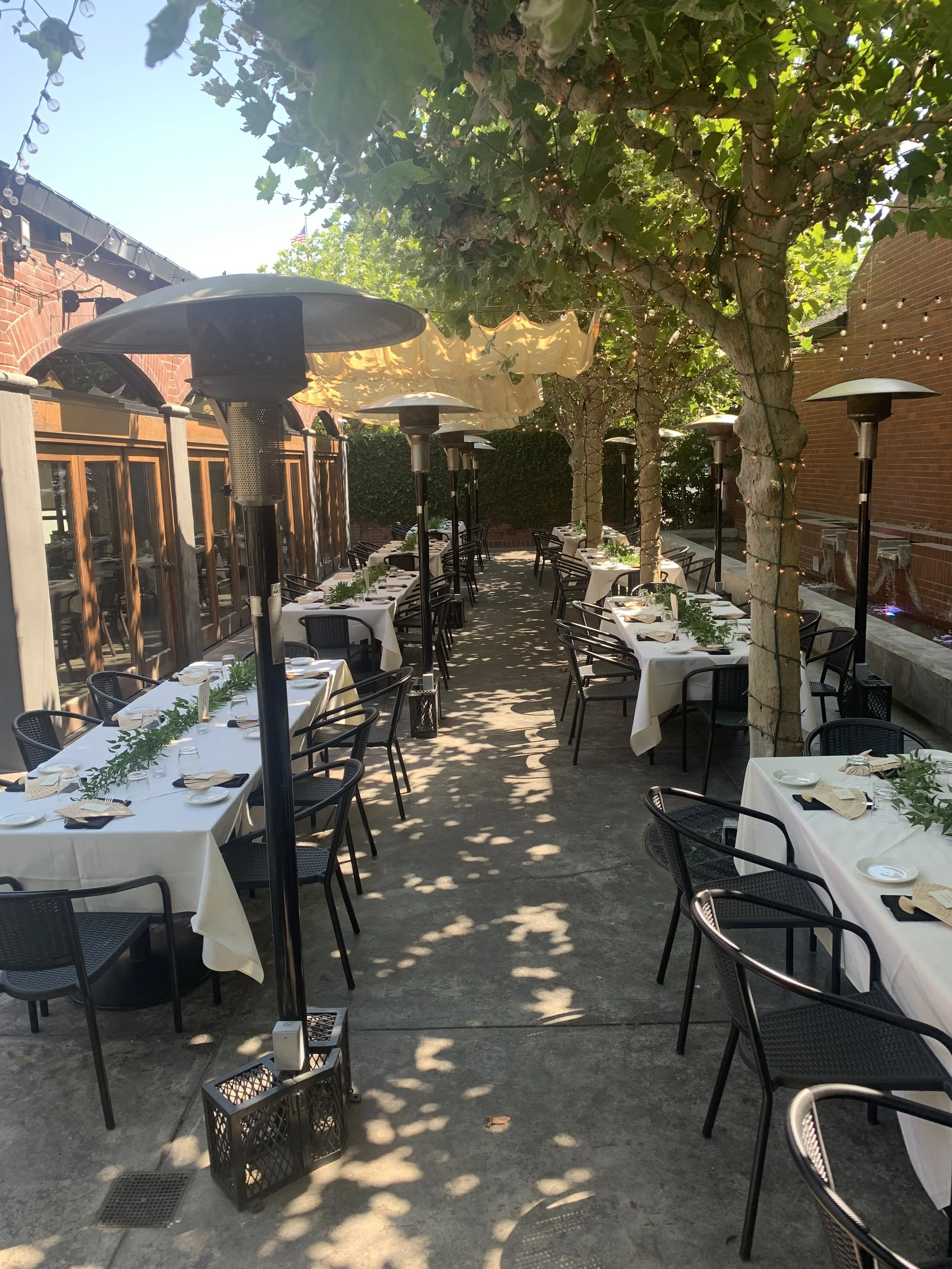 the patio with an assortment of tables set up for an event