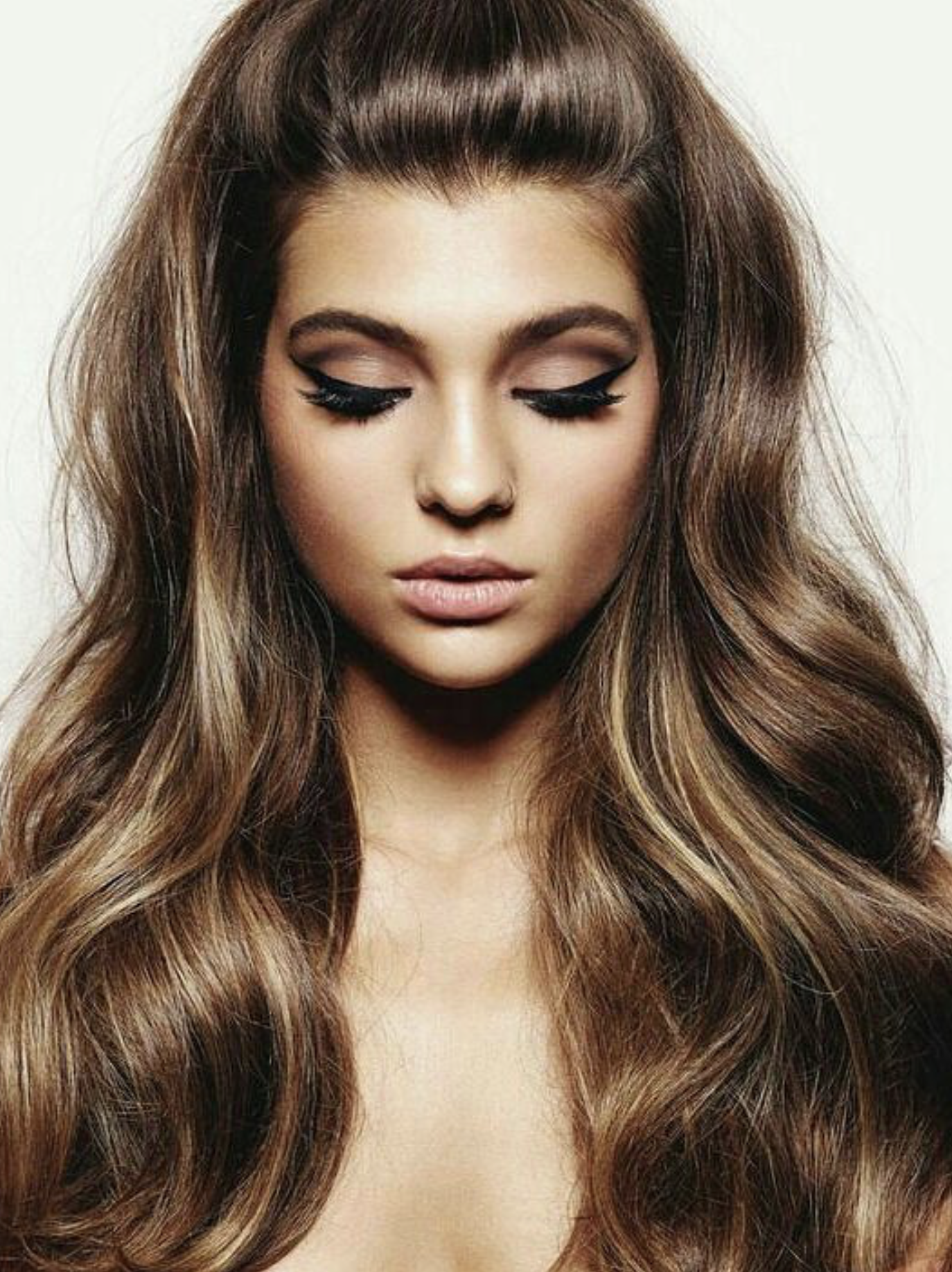 ong brunette extensions with soft, polished waves.