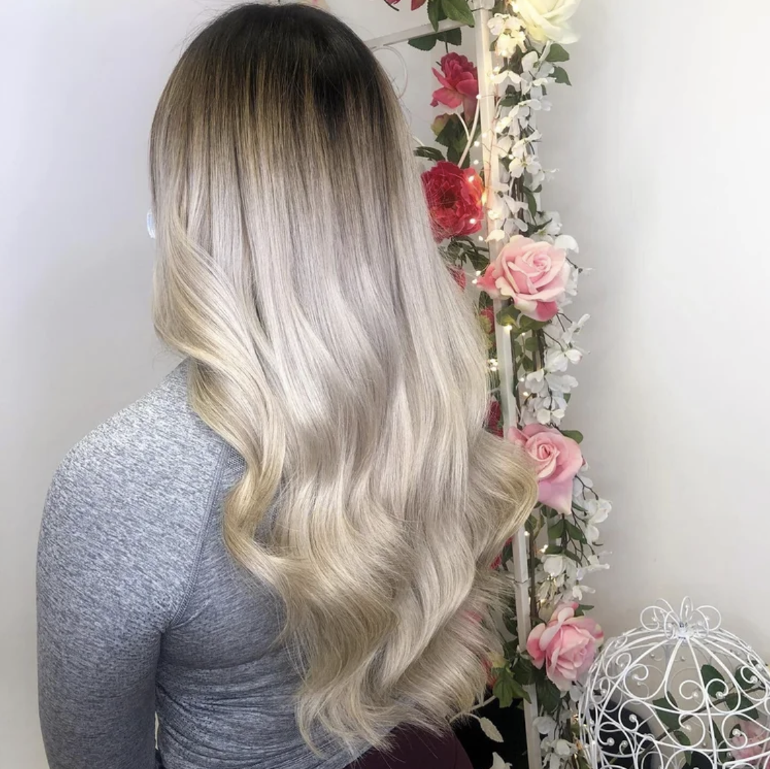 Seamless silver blonde extensions with soft waves and a natural blend.