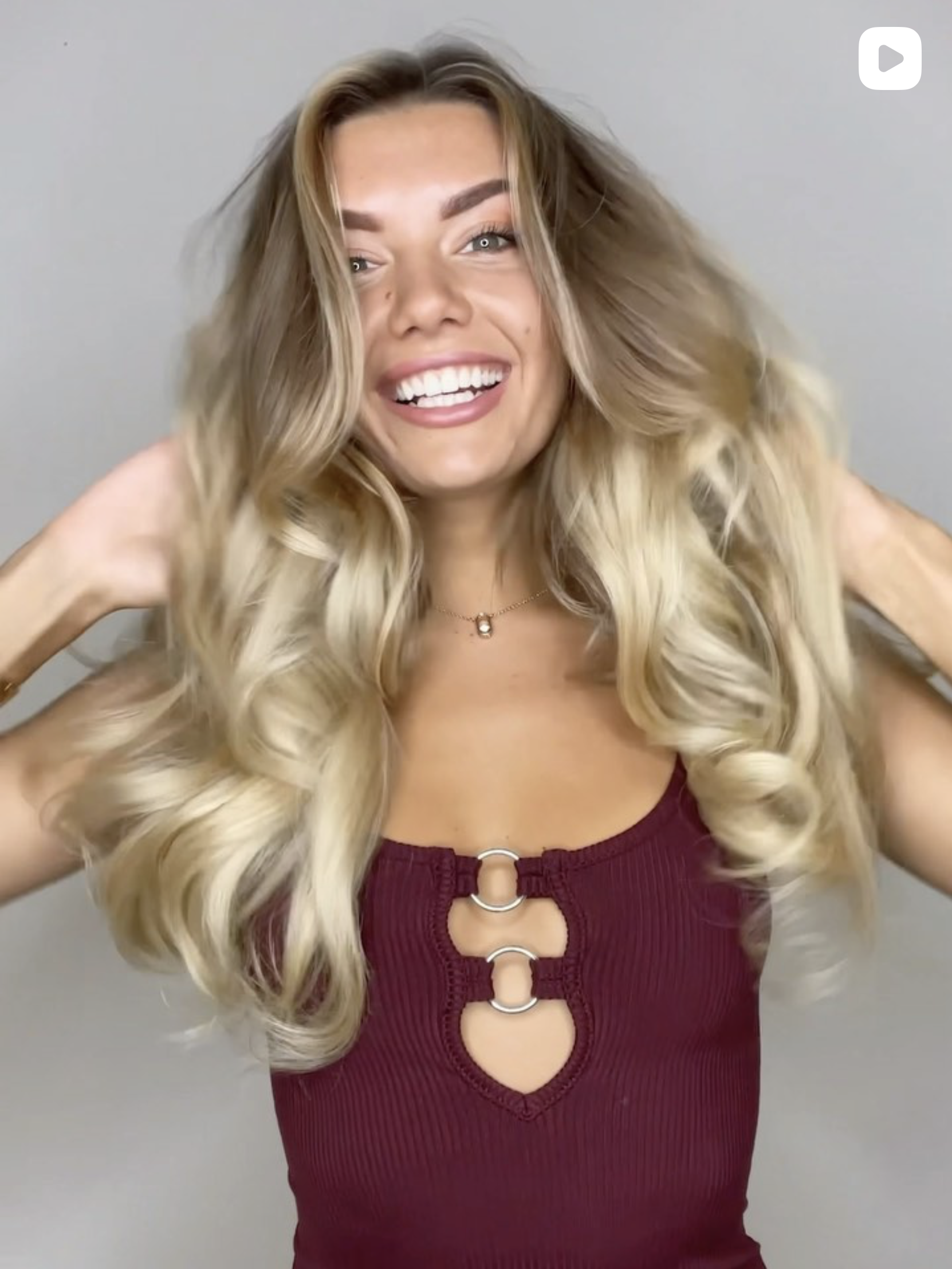 Full blonde extensions with glamorous volume and soft waves.