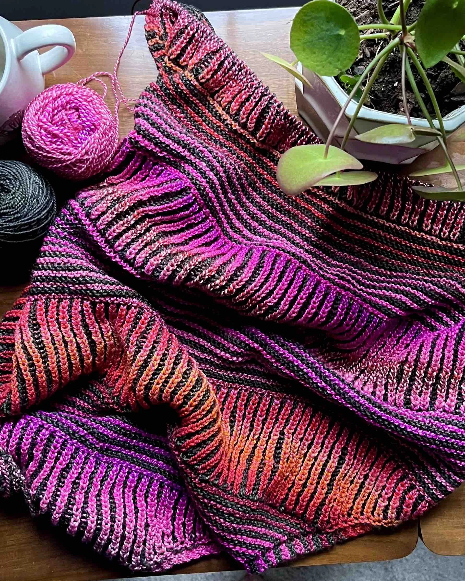 A Flat-lay of the Montrose cowl in progress, highlighting alternating bands of brioche and garter stitch