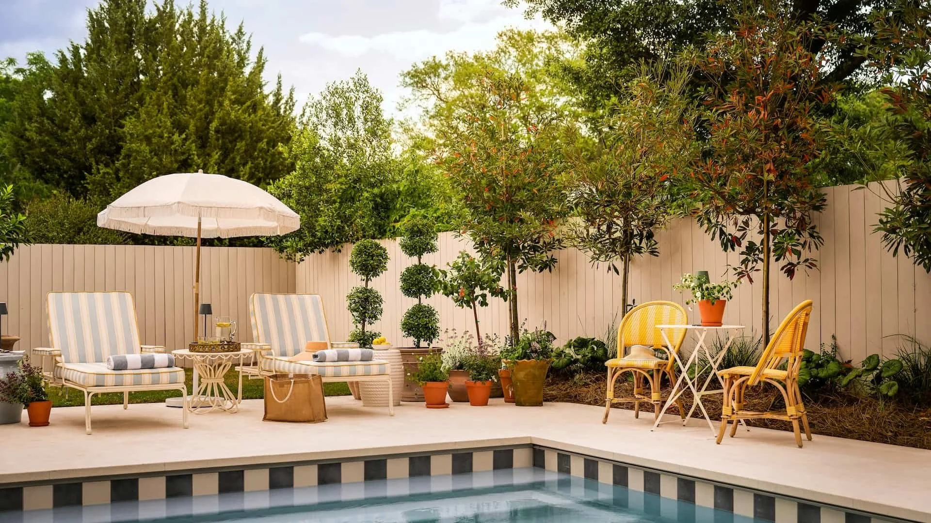 ellen-ave-pool-striped-lounge-chairs-patio.jpg