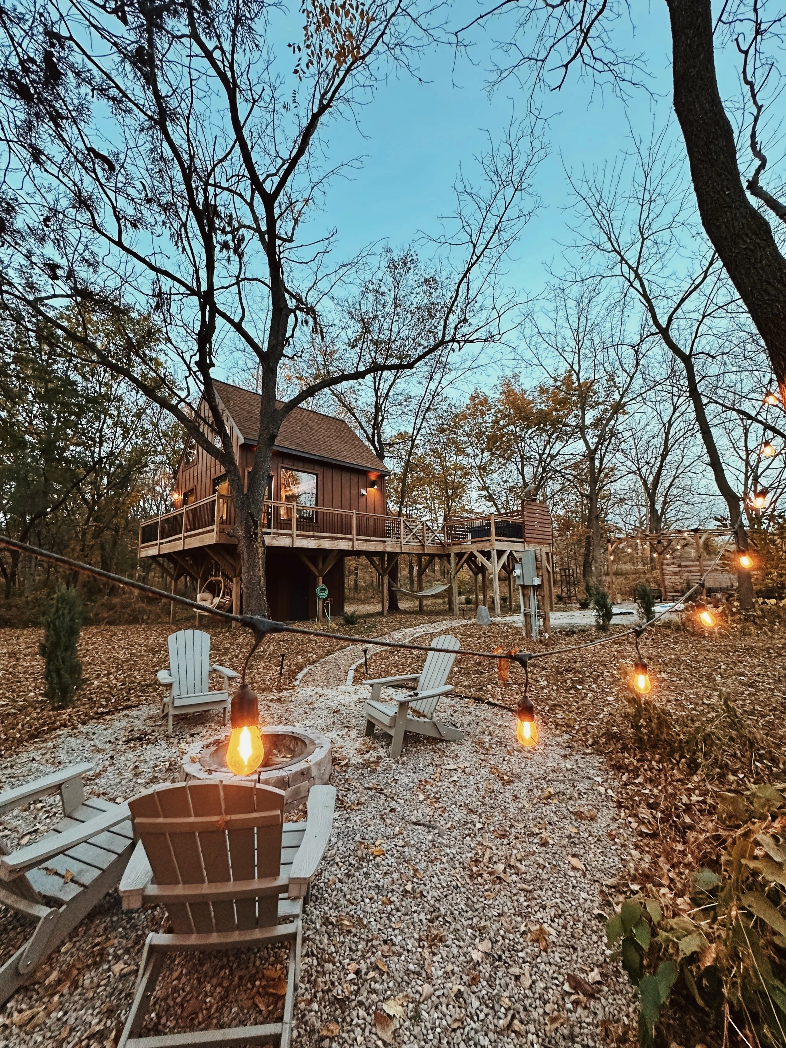 treehouse in autumn with firepit side view