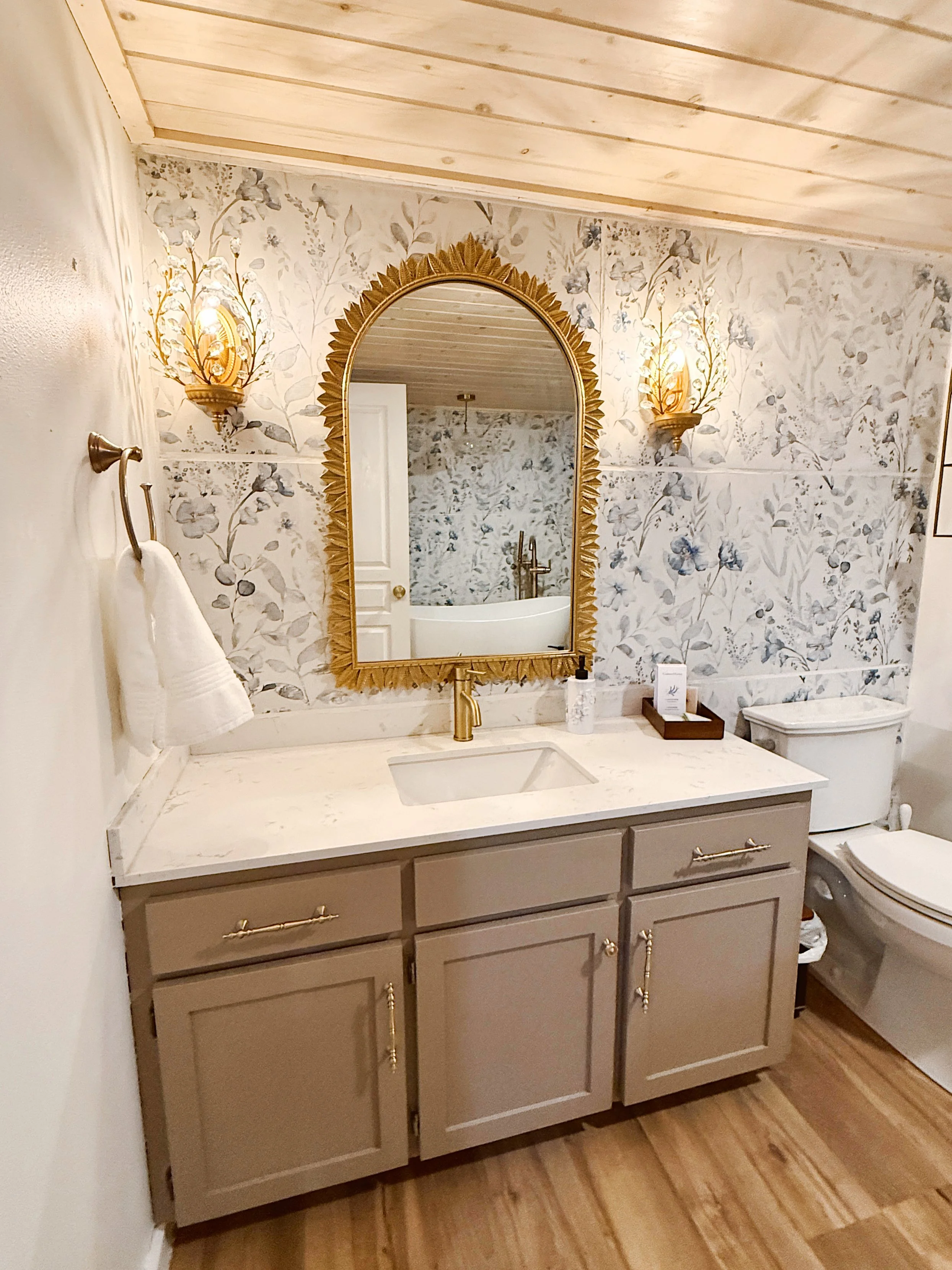 modern tiled bathroom with gold mirror