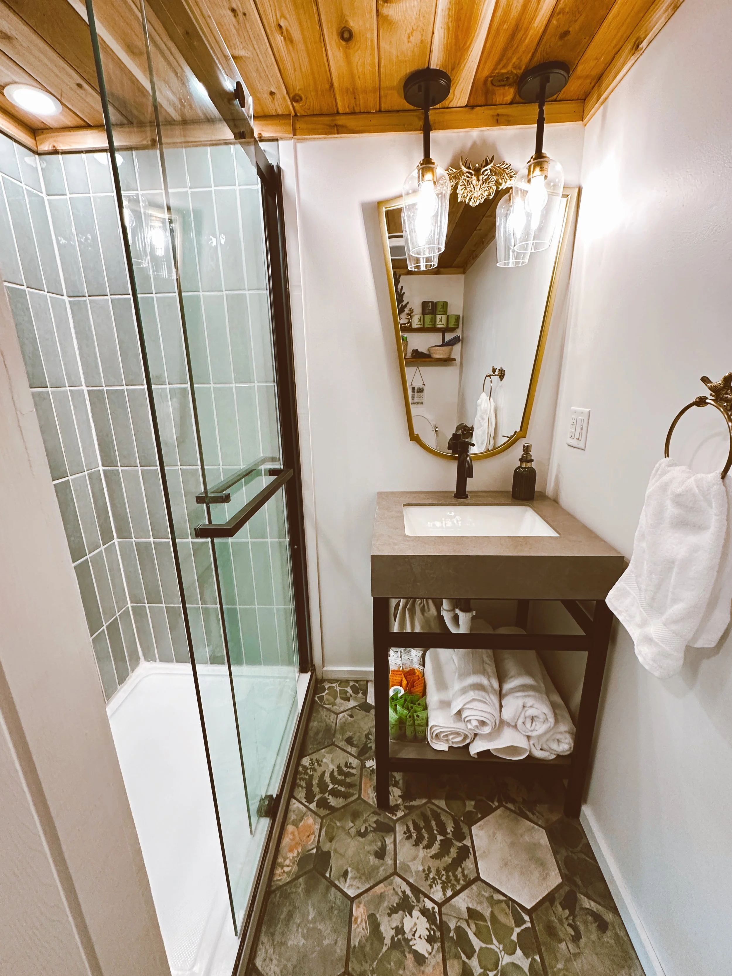 treehouse bathroom with forest floor tiles and shower