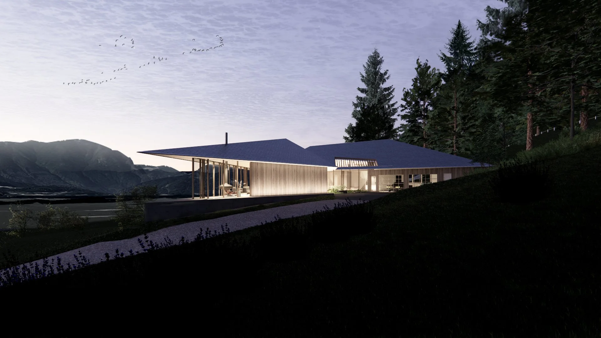 Modern luxury single family residence in British Columbia designed by X Architecture. Striking contemporary home with warm wood cladding, expansive glass walls, and dramatic mountain views at dusk.