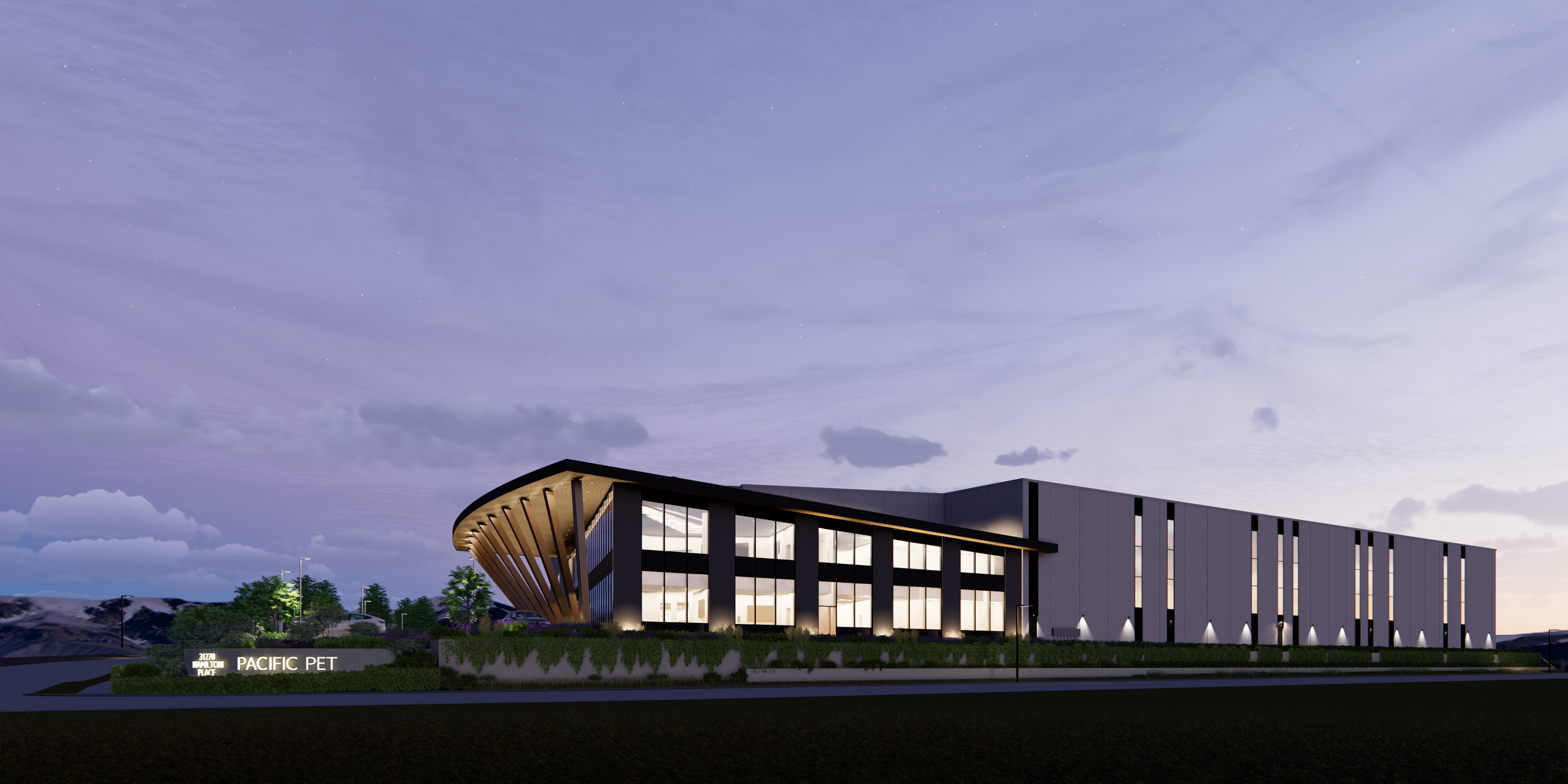 Modern building with glass windows and wooden accents, surrounded by landscaping, at dusk with a cloudy sky.