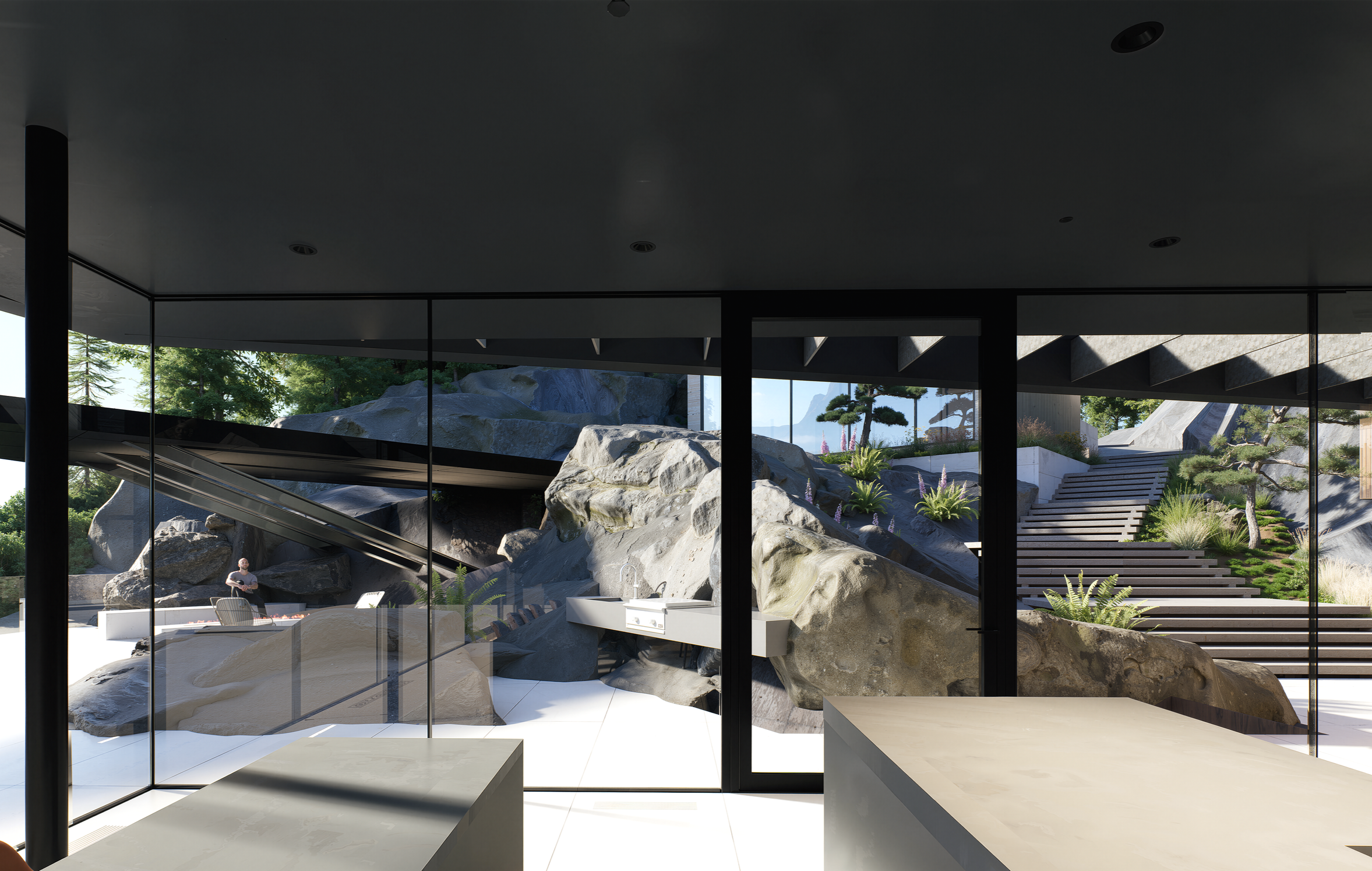 North Vancouver luxury oceanfront home by X Architecture. Interior view looking out to modern outdoor barbecue area with dramatic natural rock formations and Pacific Ocean views.