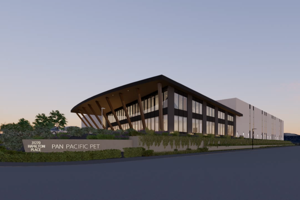 Modern commercial building for Pan Pacific Pet in Mission BC designed by X Architecture. Striking curved roof, warm wood accents, and expansive glass windows create this contemporary facility.