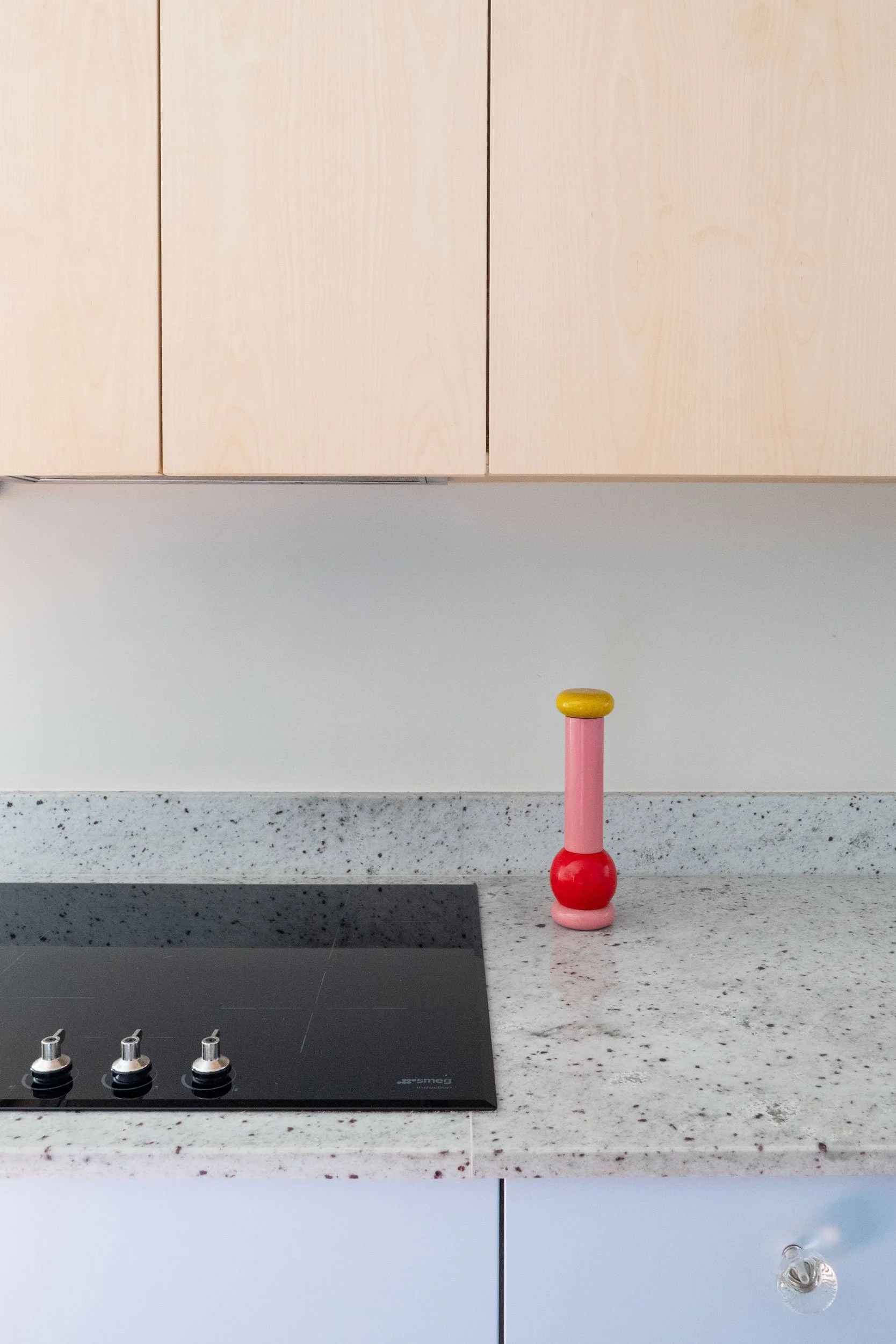 The Pomo Kitchen in Stockholm by Studio Navet — pastel blue cabinetry, natural wood, granite counter, and terracotta tiles in a postmodern apartment.
