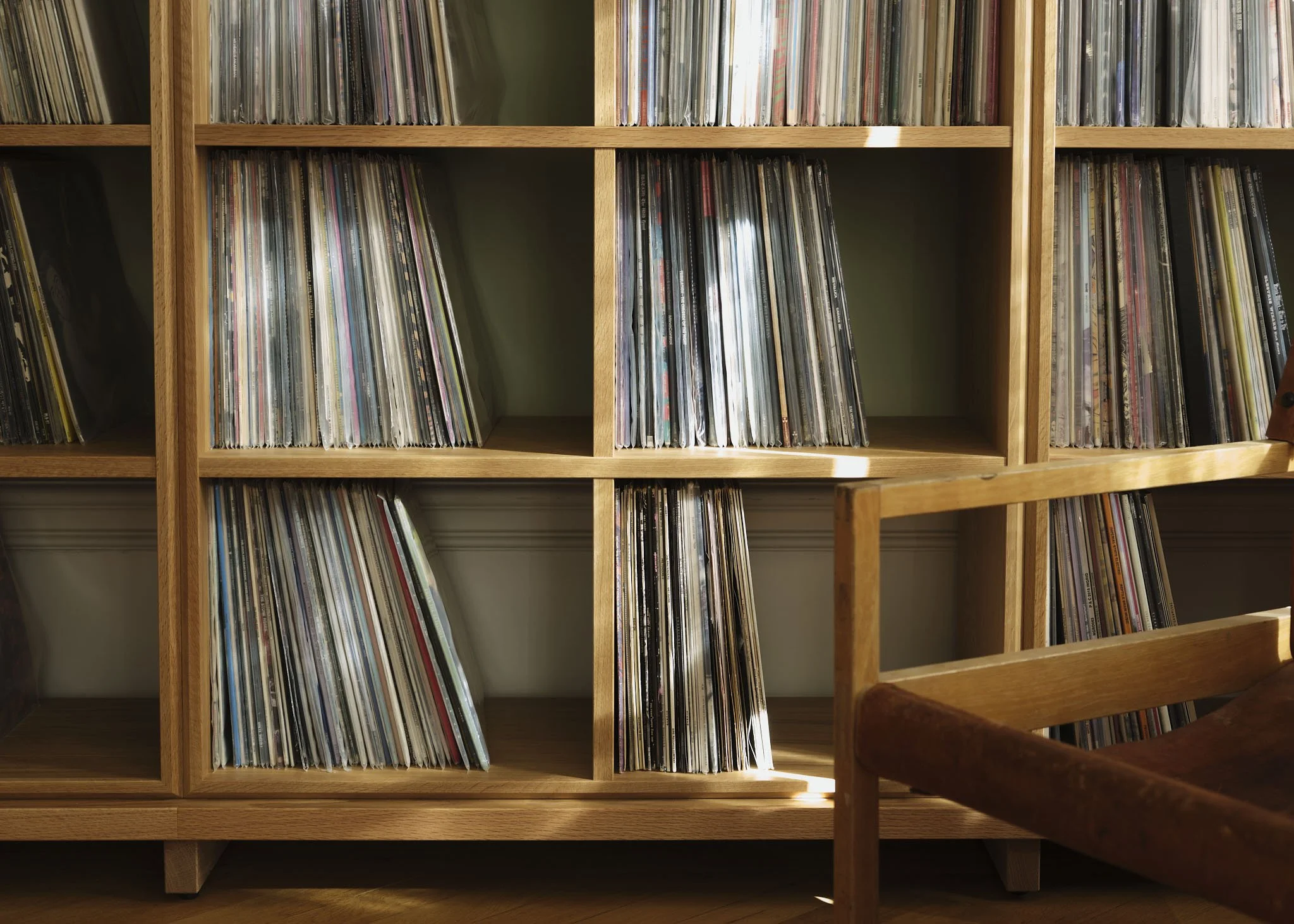 Music room in an Östermalm apartment, Stockholm, by Studio Navet — modular solid oak shelf and blue-stained record cabinet.