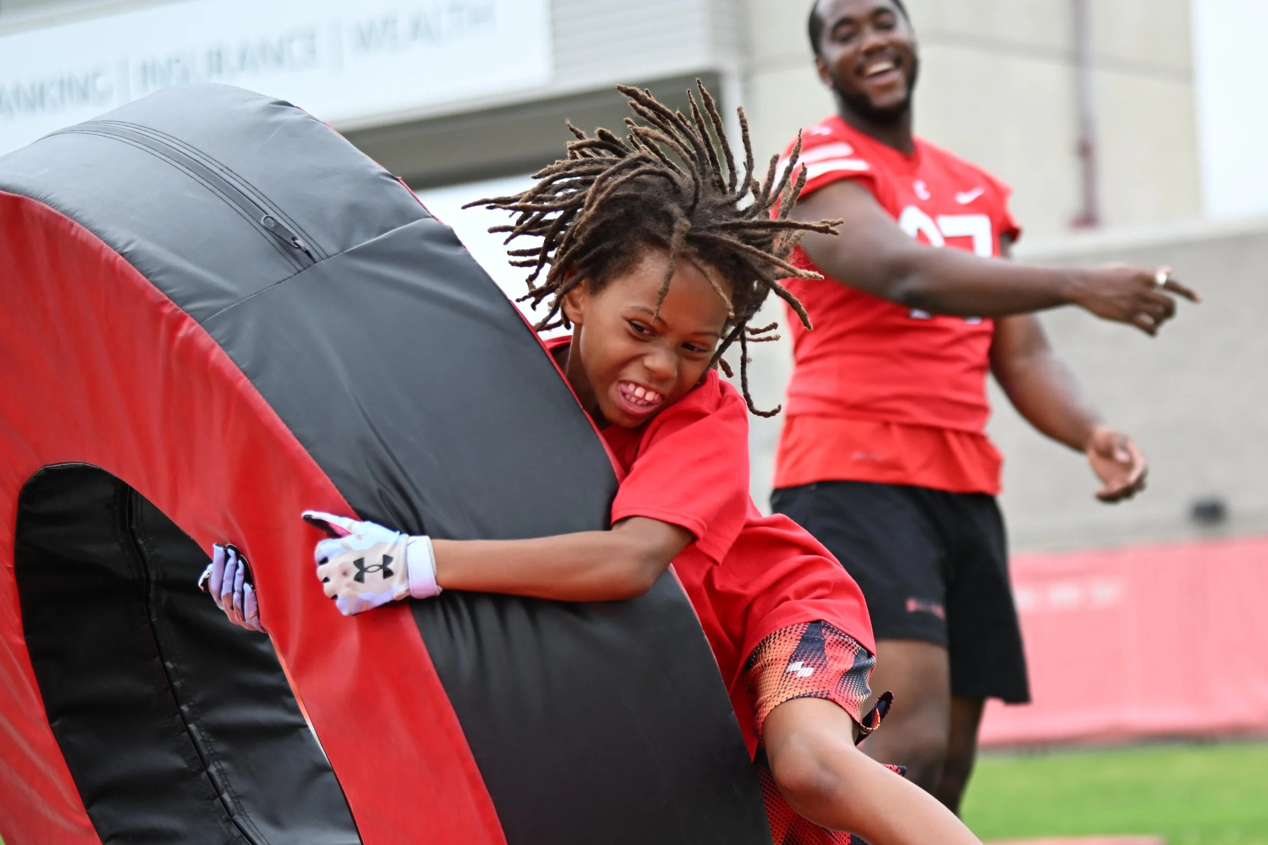 A camper takes down a tackle ring pad during a drill on Aug. 17, 2024 at Schoellkopf Field in Ithaca, NY.  Cornell Football host the program’s first CUBS Camp for children ages 12 and under.