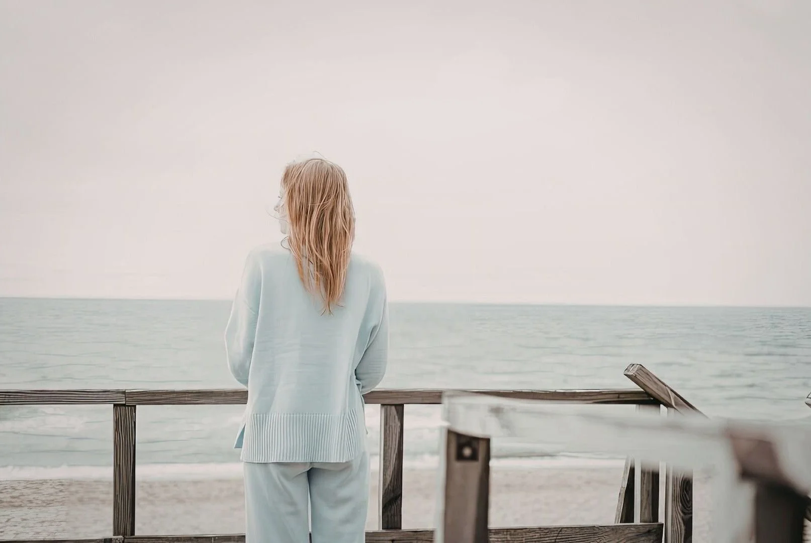 Person gazing toward the horizon representing feeling stuck, uncertain, and searching for life direction