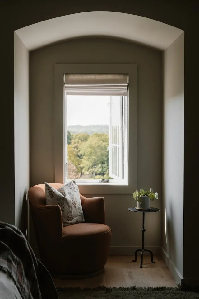 Warm interior with armchair by a window representing spiritual counselling and grounded emotional support