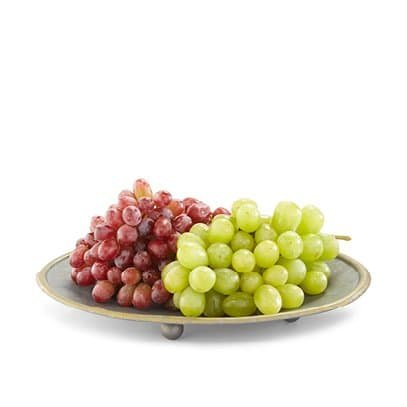 Red and green organic grapes on a plate
