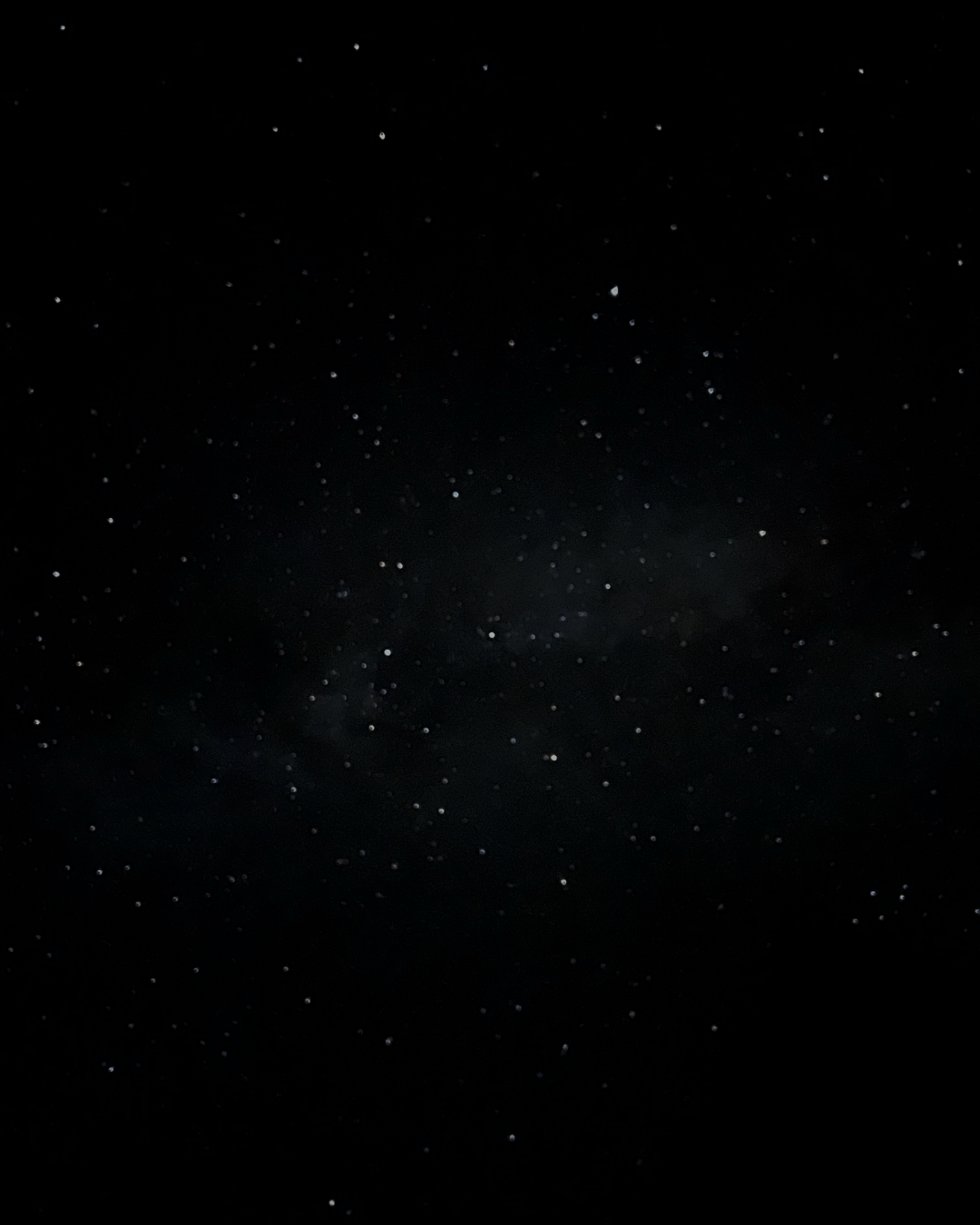 Dark sky filled with numerous stars and faint clouds of the Milky Way galaxy.