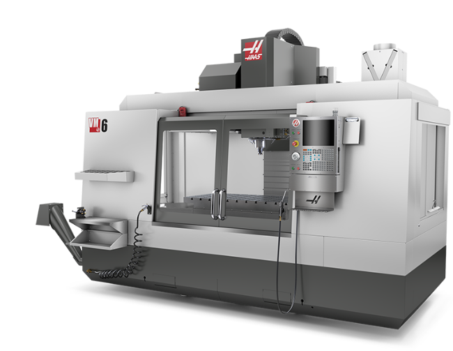 A large white CNC machine with the brand name Fadal on the side, featuring a control panel with a display screen and buttons, used for manufacturing or machining parts.