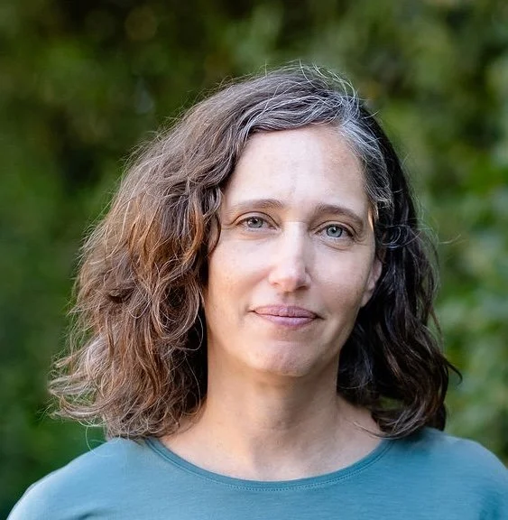 A smiling woman with brown hair