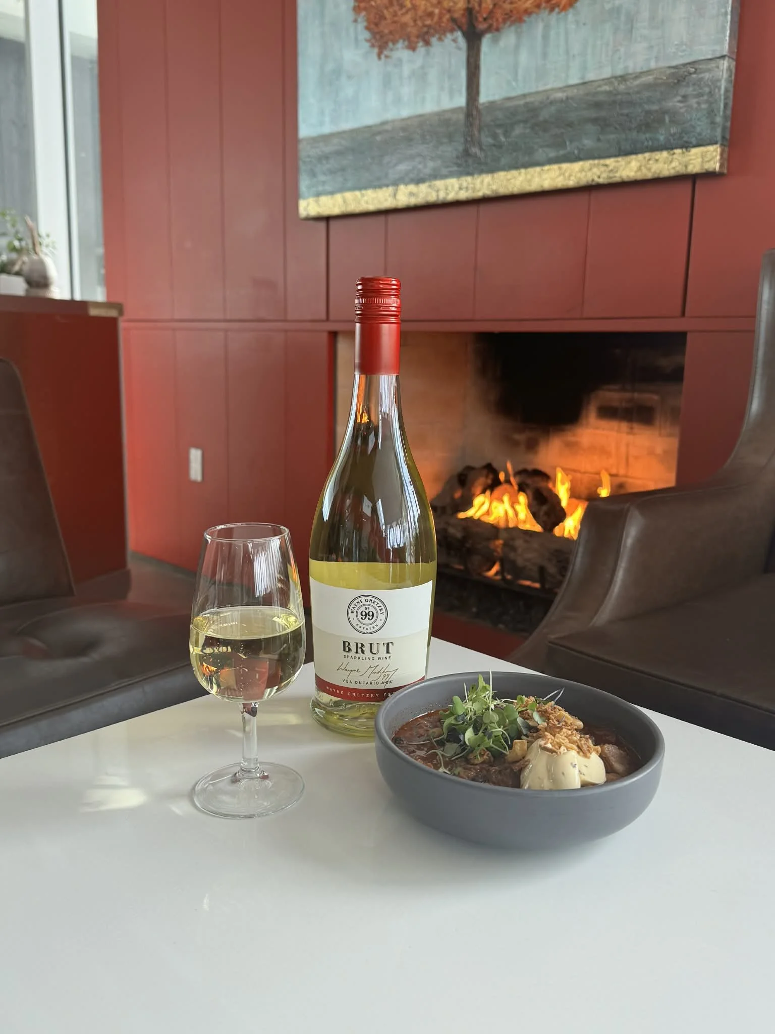 A glass of Wayne Gretzky Estates Icewine paired with a butter tart on a branded napkin