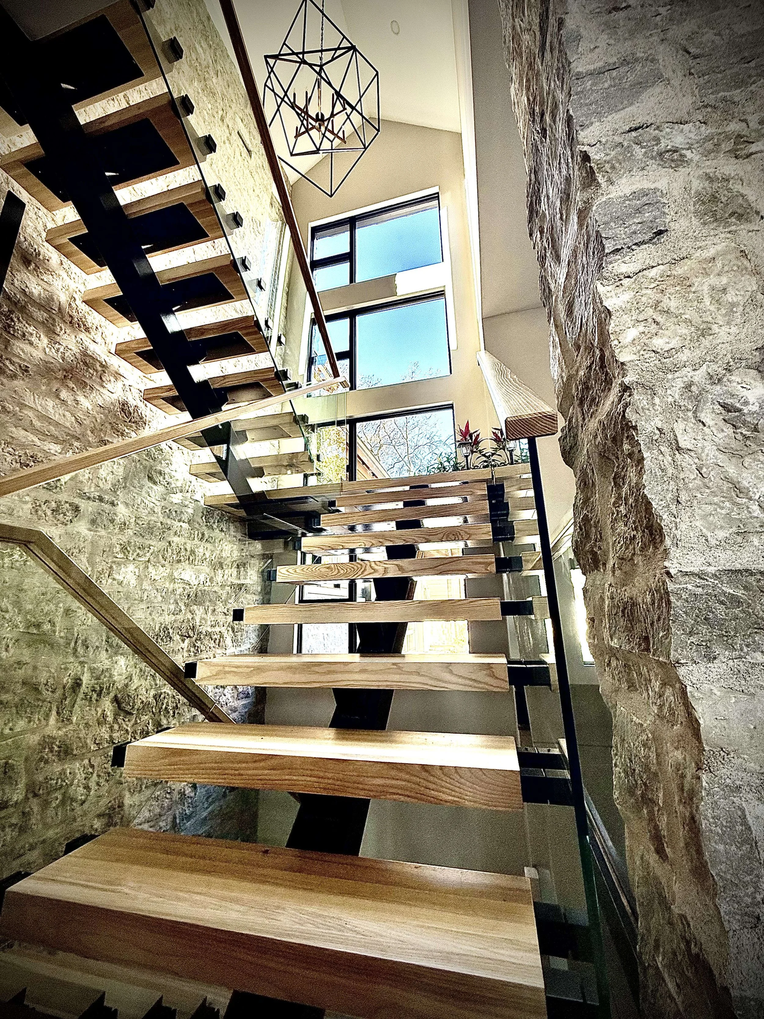 Modern wood and metal staircase with glass railing