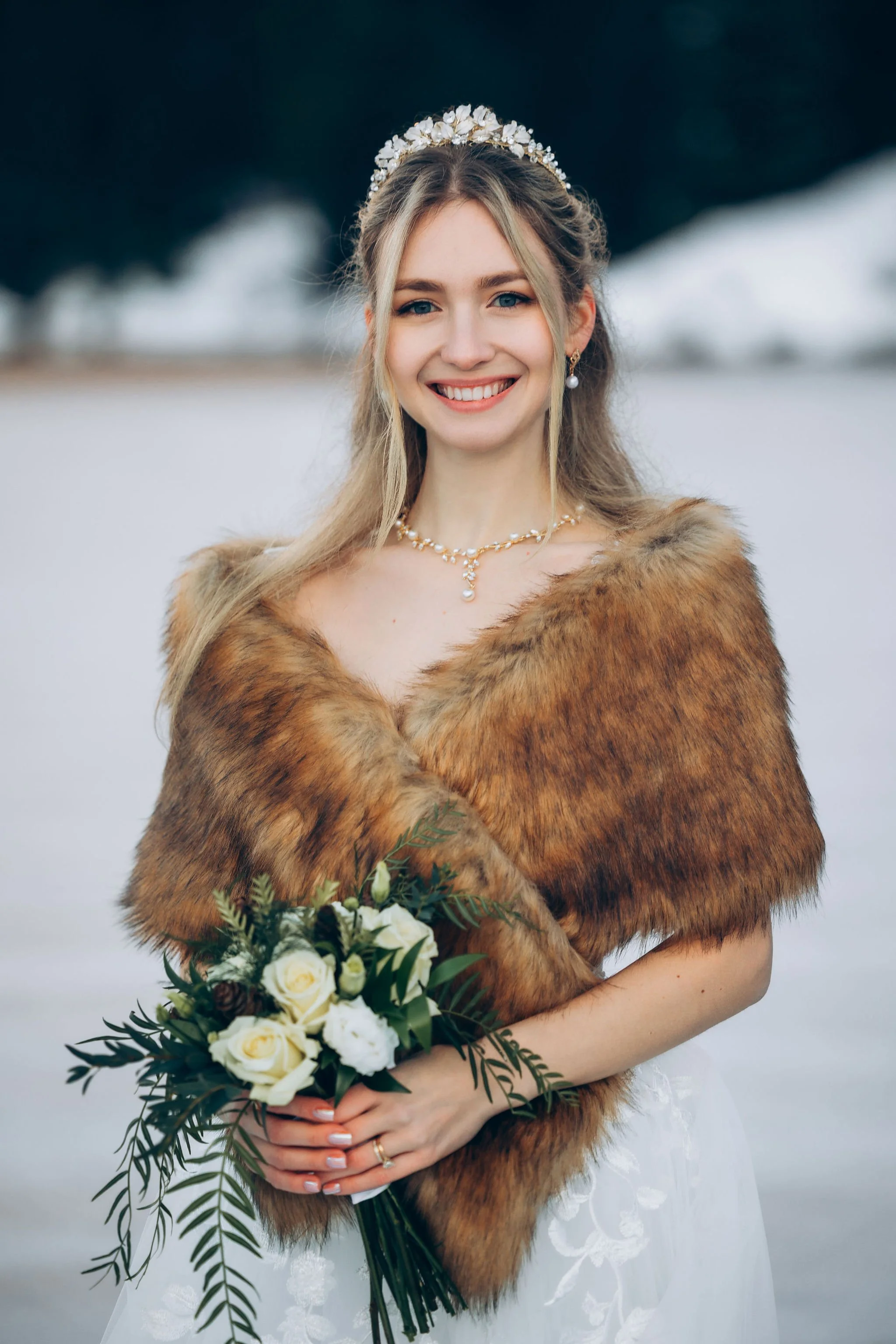 Bride wearing an elopement dress with a faux fur wrap, pearl jewelry, and a crystal hairpiece, showing how thoughtful accessories complete a unique bridal look