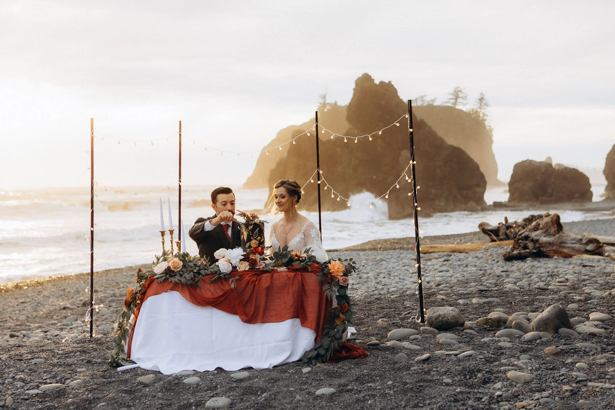 Couple having a styled beach elopement reception at Ruby Beach in Olympic National Park
