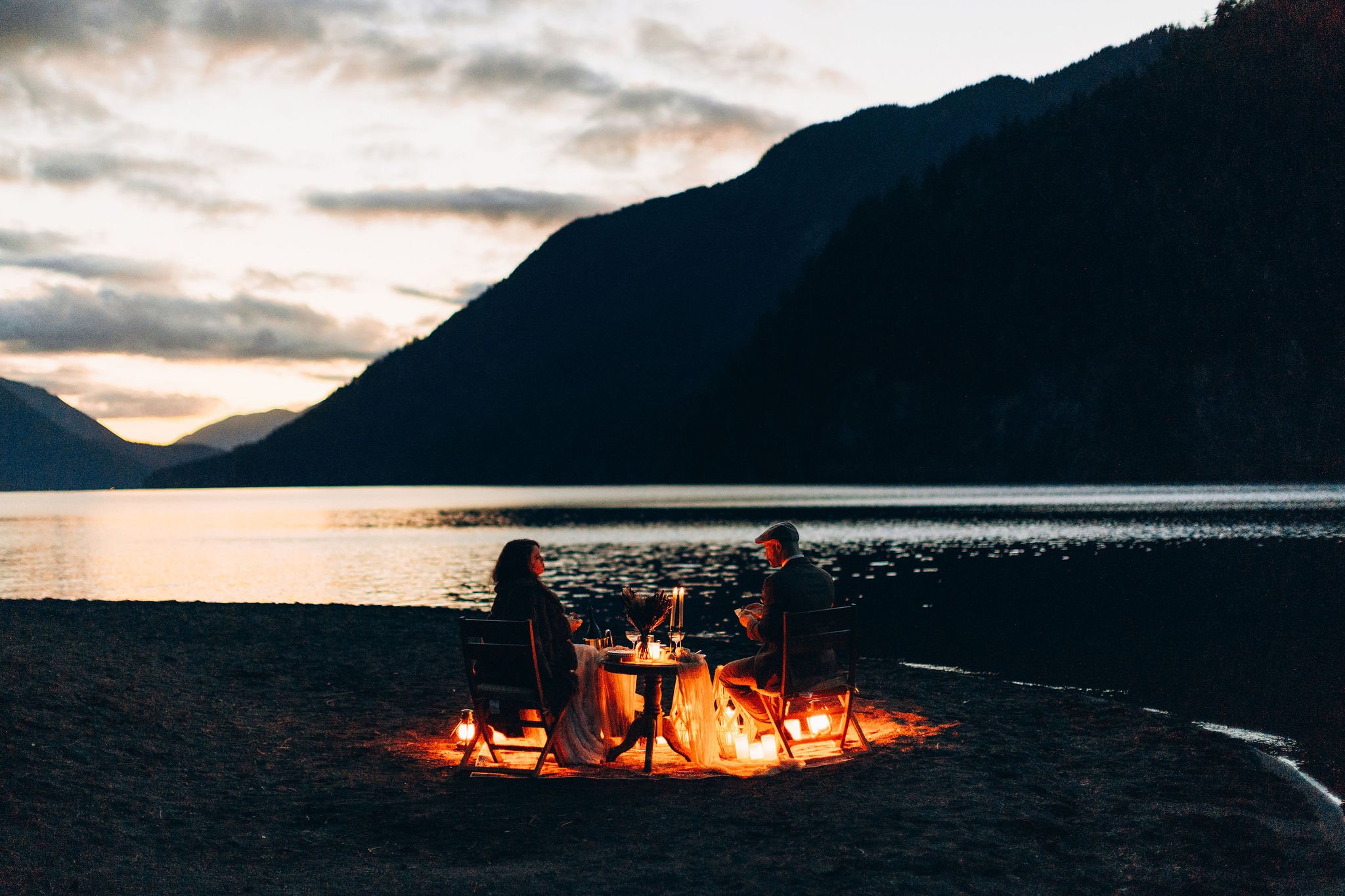 Couple having a candlelit elopement dinner at Lake Crescent in Olympic National Park