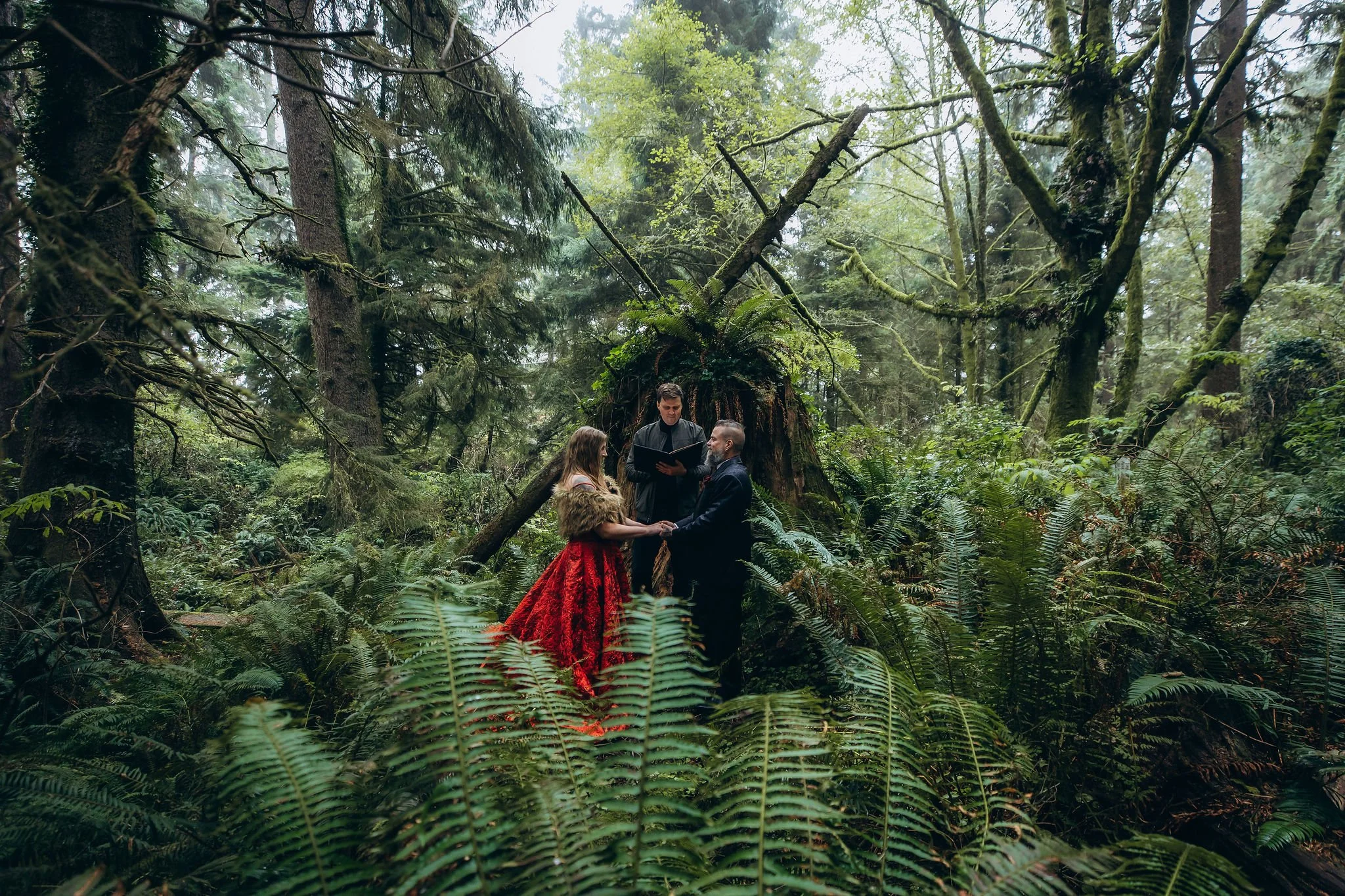 Couple exchanging vows during an intimate forest elopement ceremony in the woods of Ecola State Park on the Oregon Coast