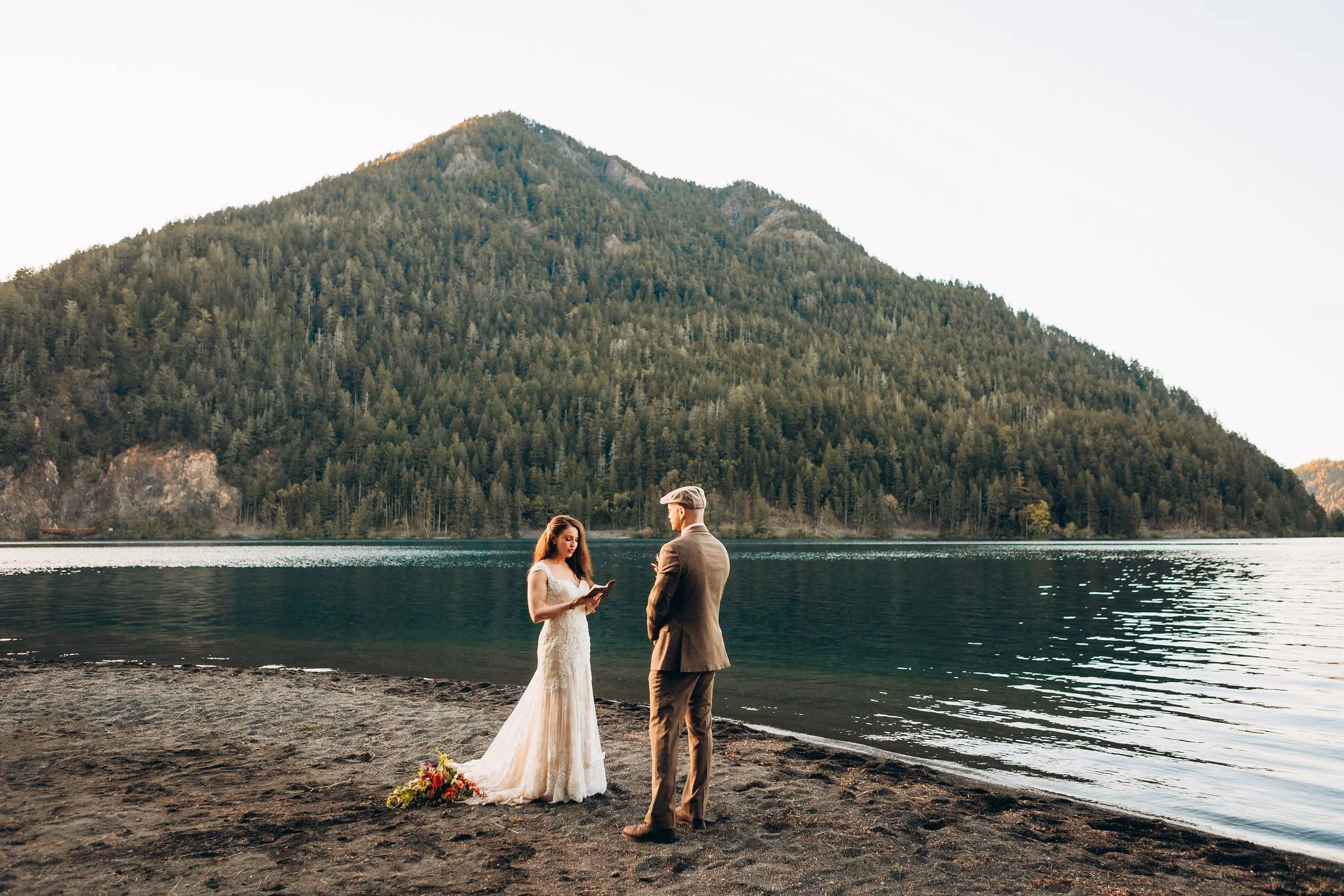 Couple exchanging private vows during a Lake Crescent elopement at sunset in Olympic National Park