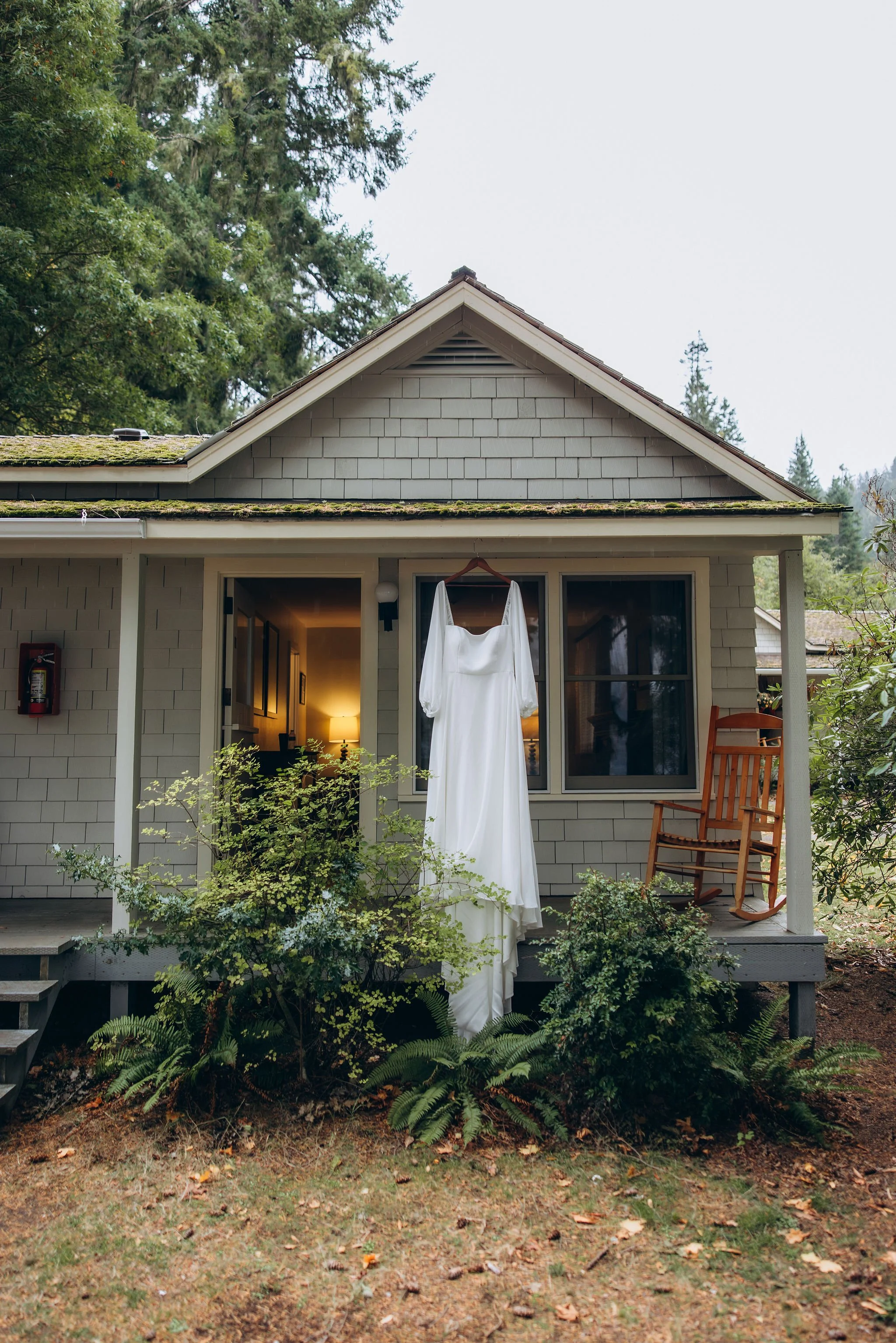Wedding dress hanging outside Lake Crescent Lodge during an elopement in Olympic National Park