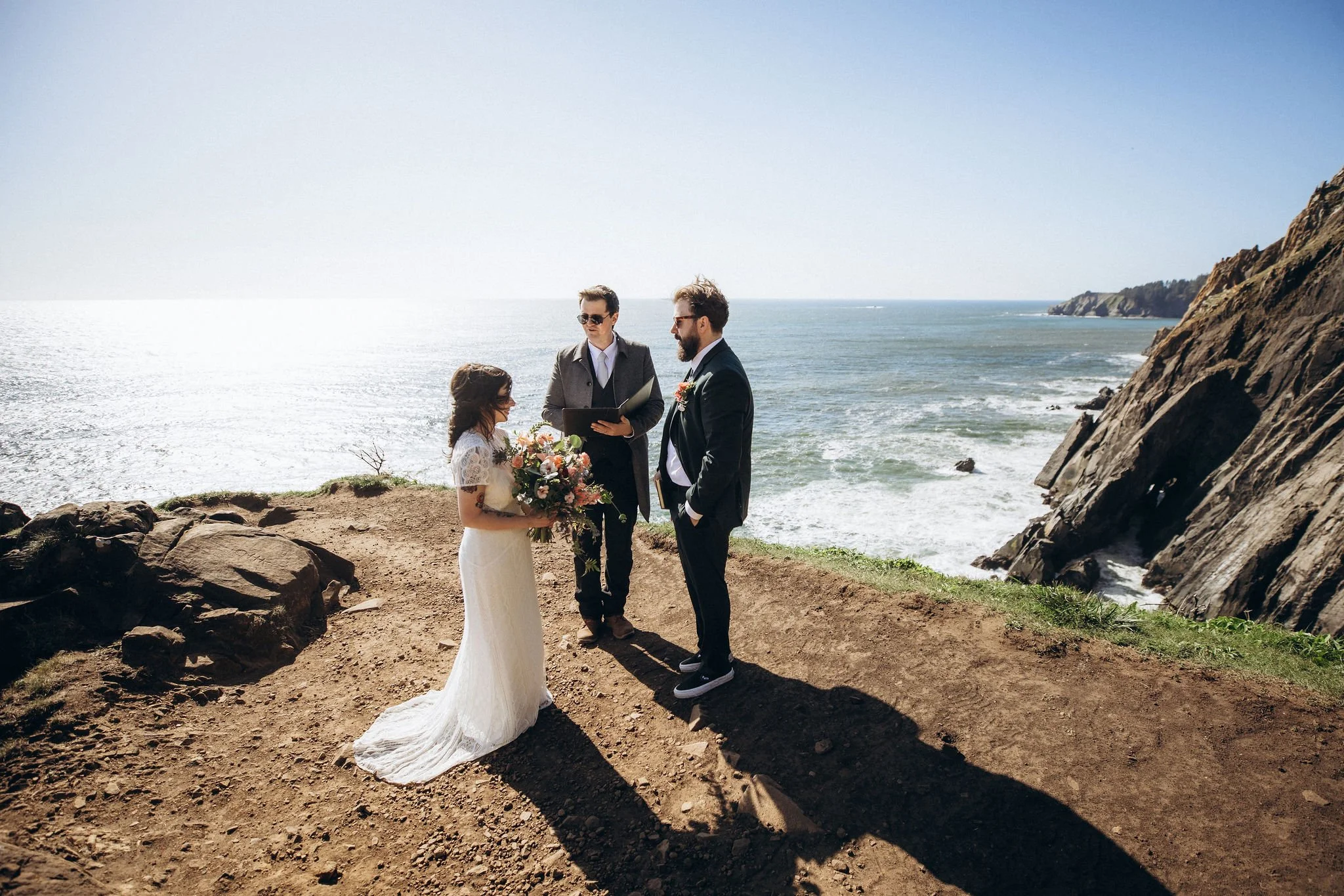 Cliffside elopement ceremony at Devil’s Cauldron and Elk Flats on the Oregon Coast, with the couple exchanging vows overlooking the ocean