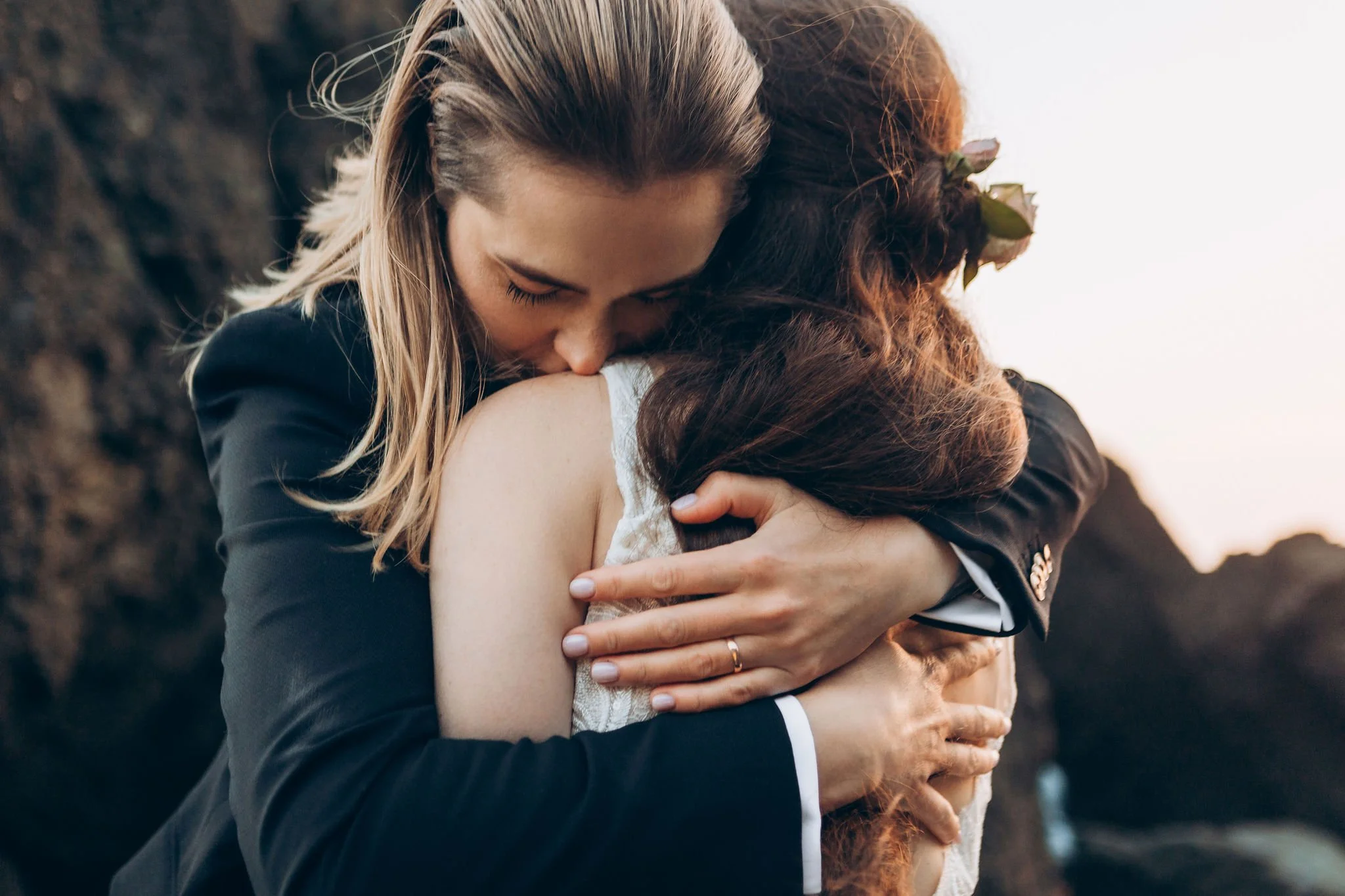 Close-up of a couple hugging during their Olympic National Park elopement on a rocky Washington coast beach.