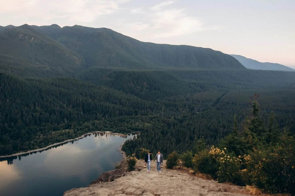 LGBTQ+ mountain elopement at Rattlesnake Ridge, featuring a meaningful ring exchange above the forest