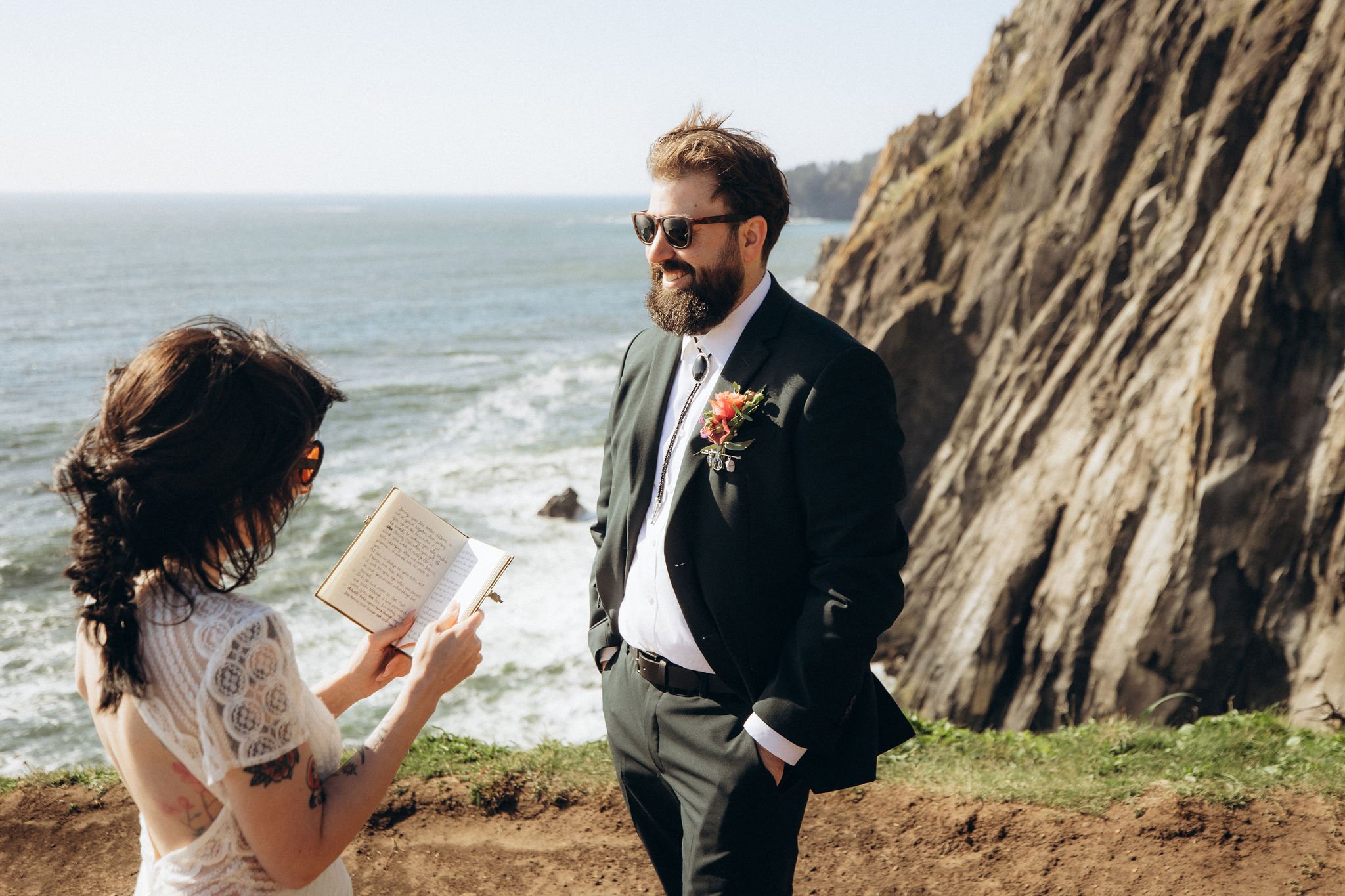 Intimate spring elopement ceremony at Elk Flats Trail near Manzanita, Oregon, with the couple exchanging vows on a coastal cliff overlooking the ocean