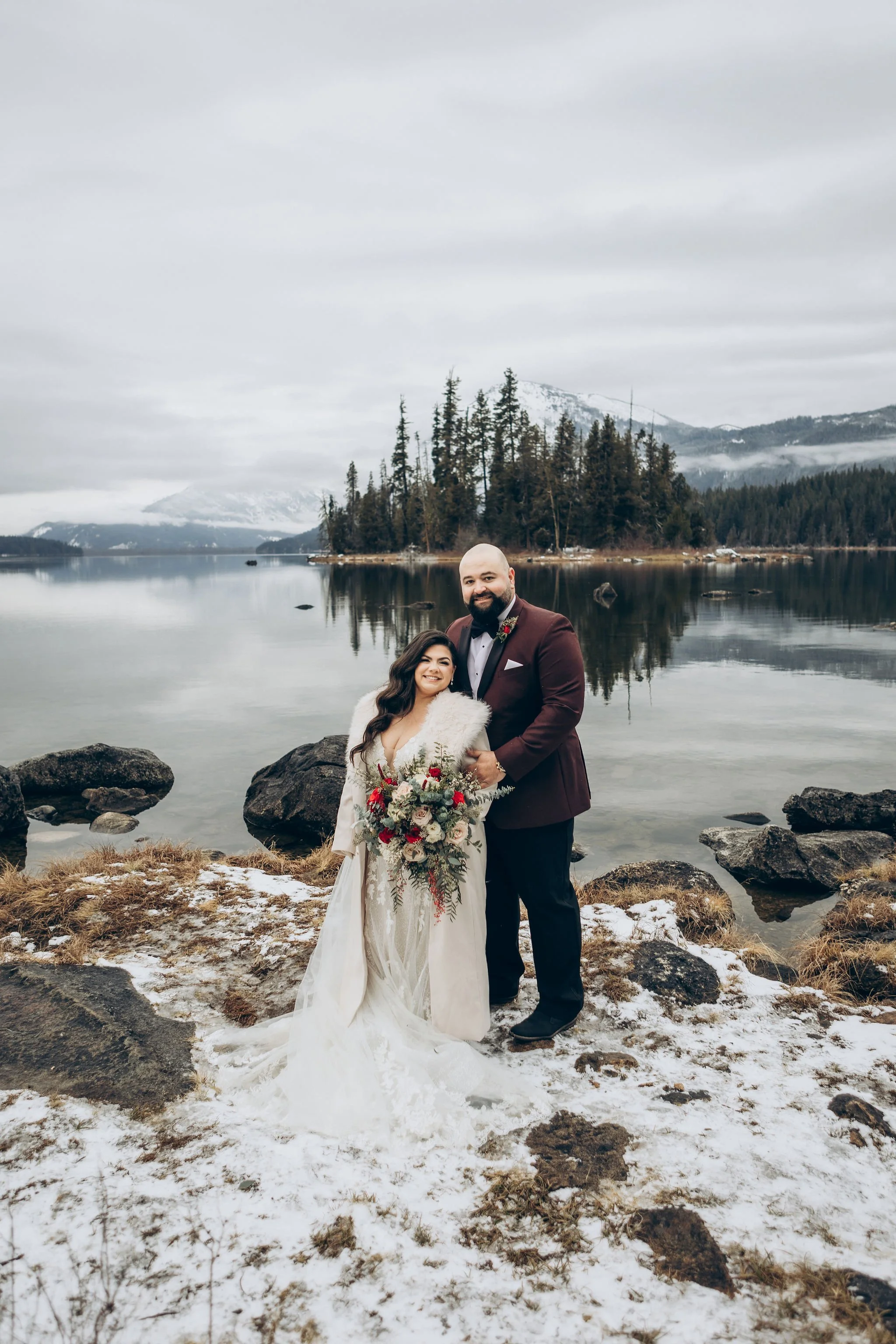 Couple posing during a snowy winter elopement at Lake Wenatchee near Leavenworth, Washington