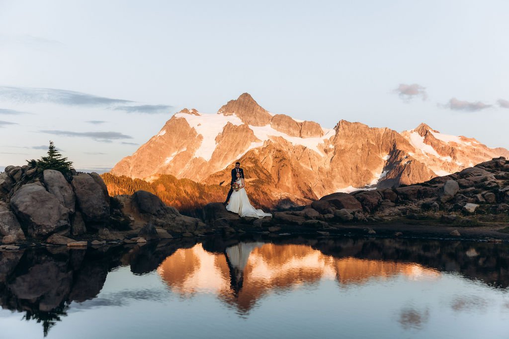 Washington State mountain elopement at Artist Point, with a couple framed by rugged peaks and water reflection