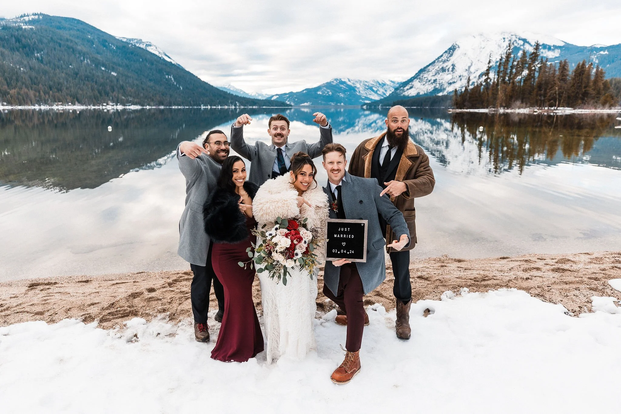 Winter intimate wedding with family celebrating at Lake Wenatchee State Park, surrounded by snow and mountain views