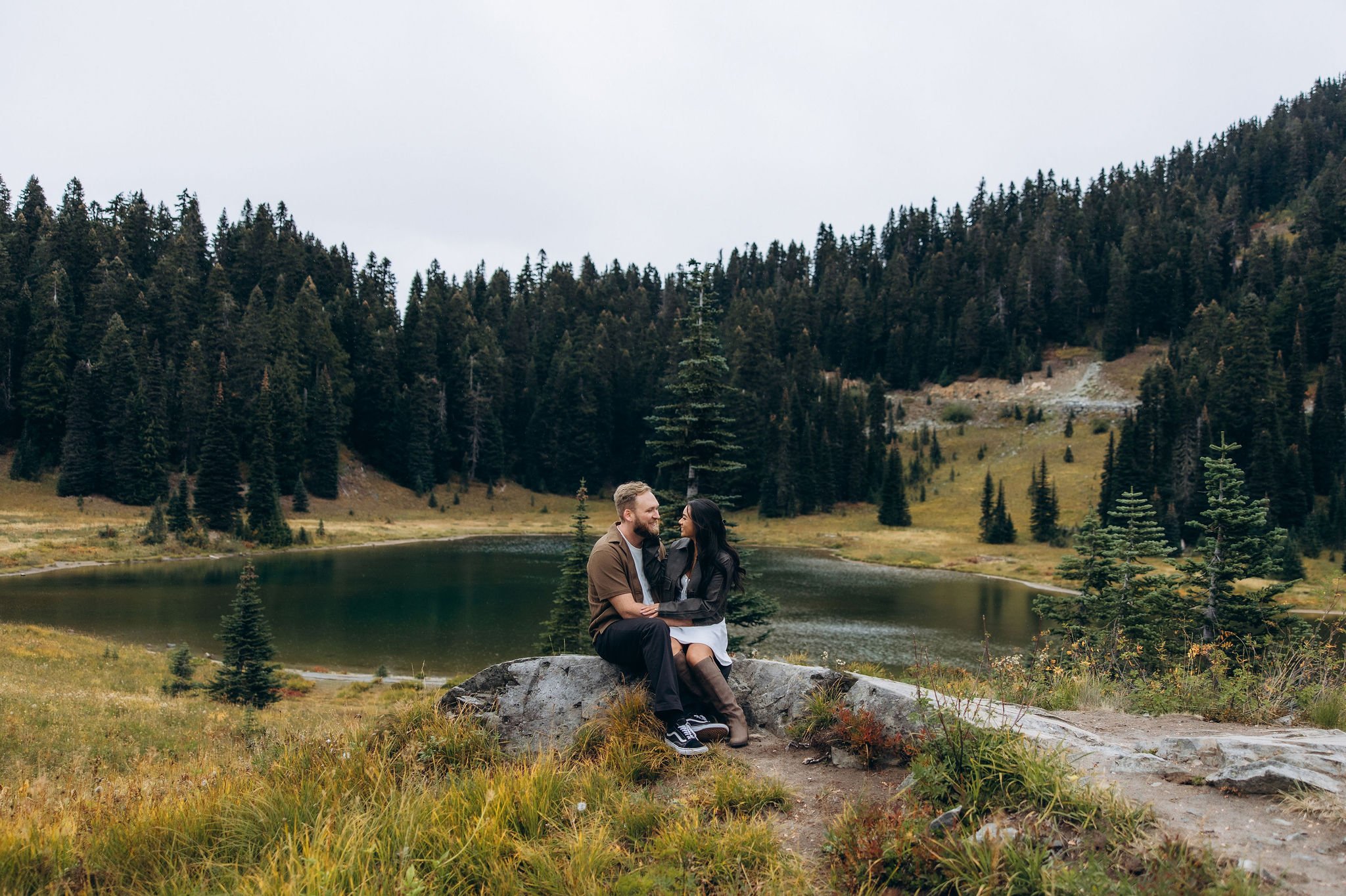 Engagement photoshoot at Tipsoo Lake surrounded by alpine meadows and evergreen forest in Mount Rainier National Park