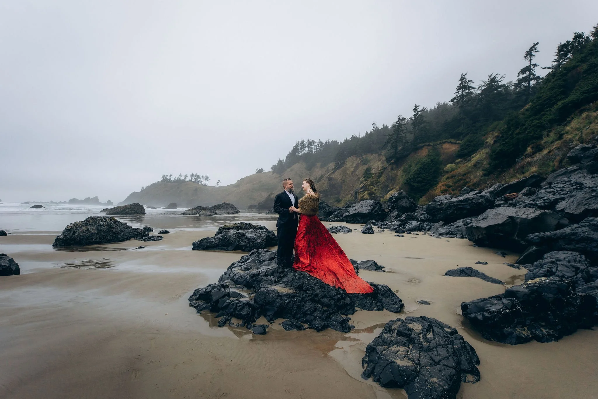 Bride wearing a vibrant red elopement dress during a beach elopement, demonstrating how bold dress colors can add personality and create dramatic contrast in outdoor wedding photos