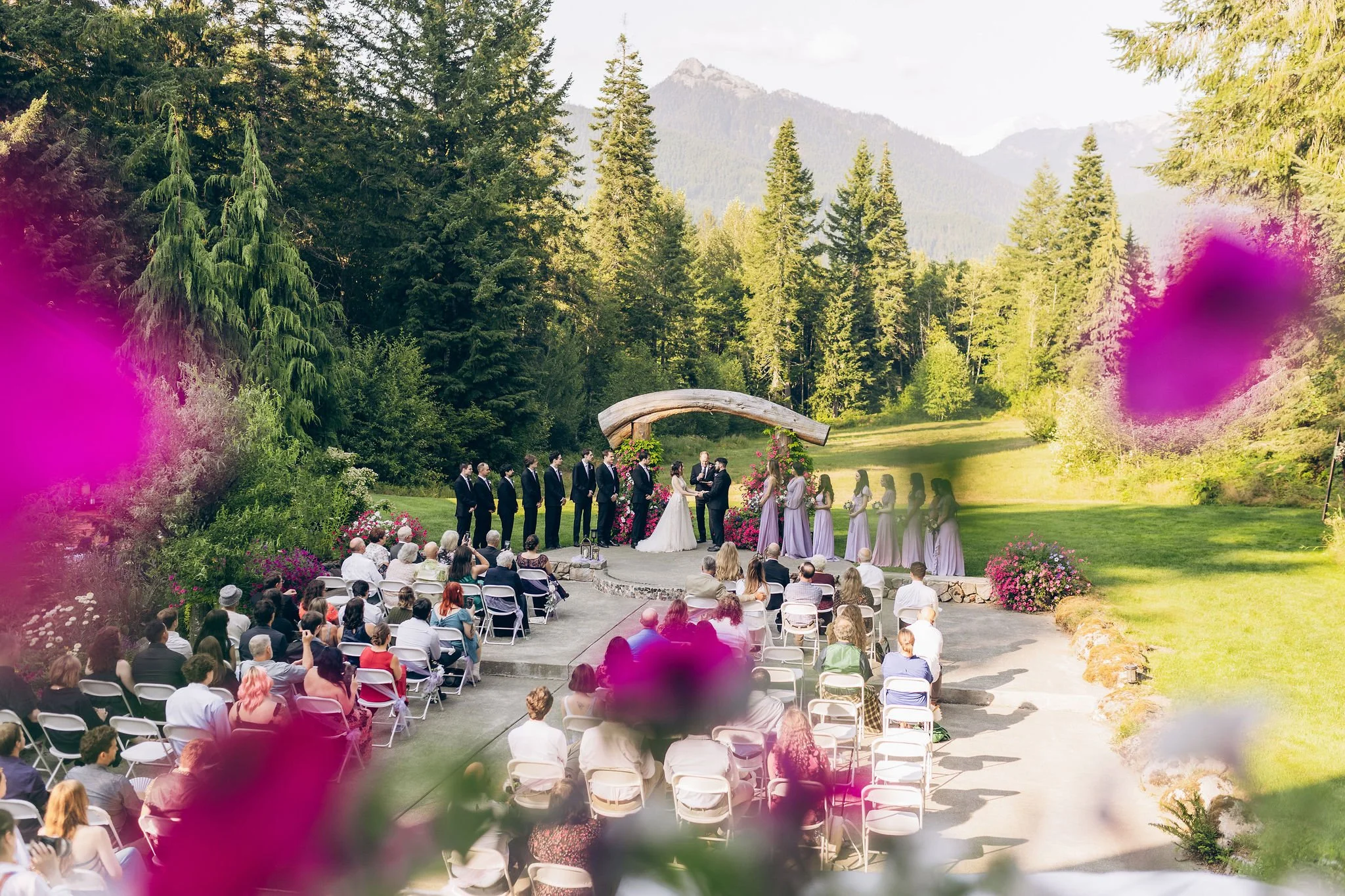 Outdoor forest wedding venue near Mount Rainier with ceremony surrounded by evergreen trees and mountain views