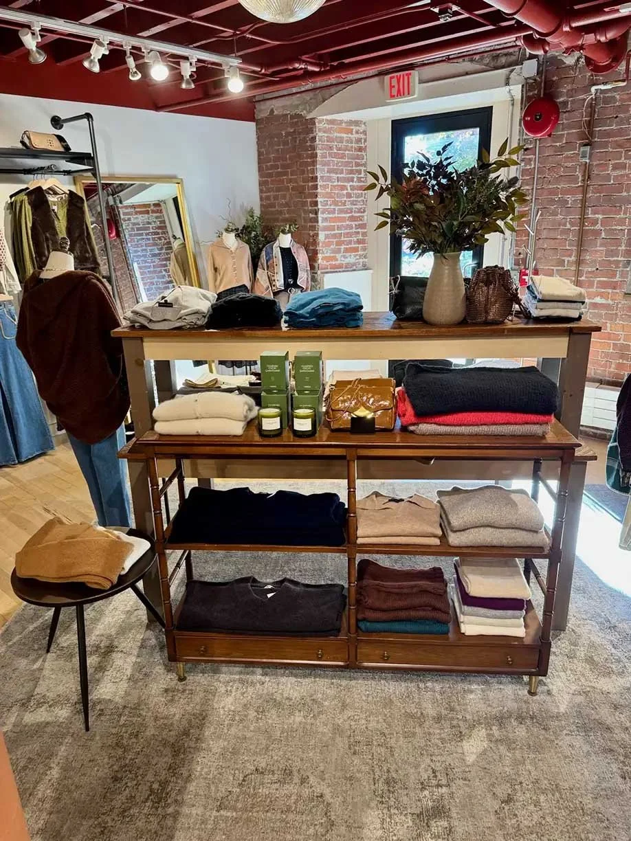 Shelving behind main table with folded sweaters