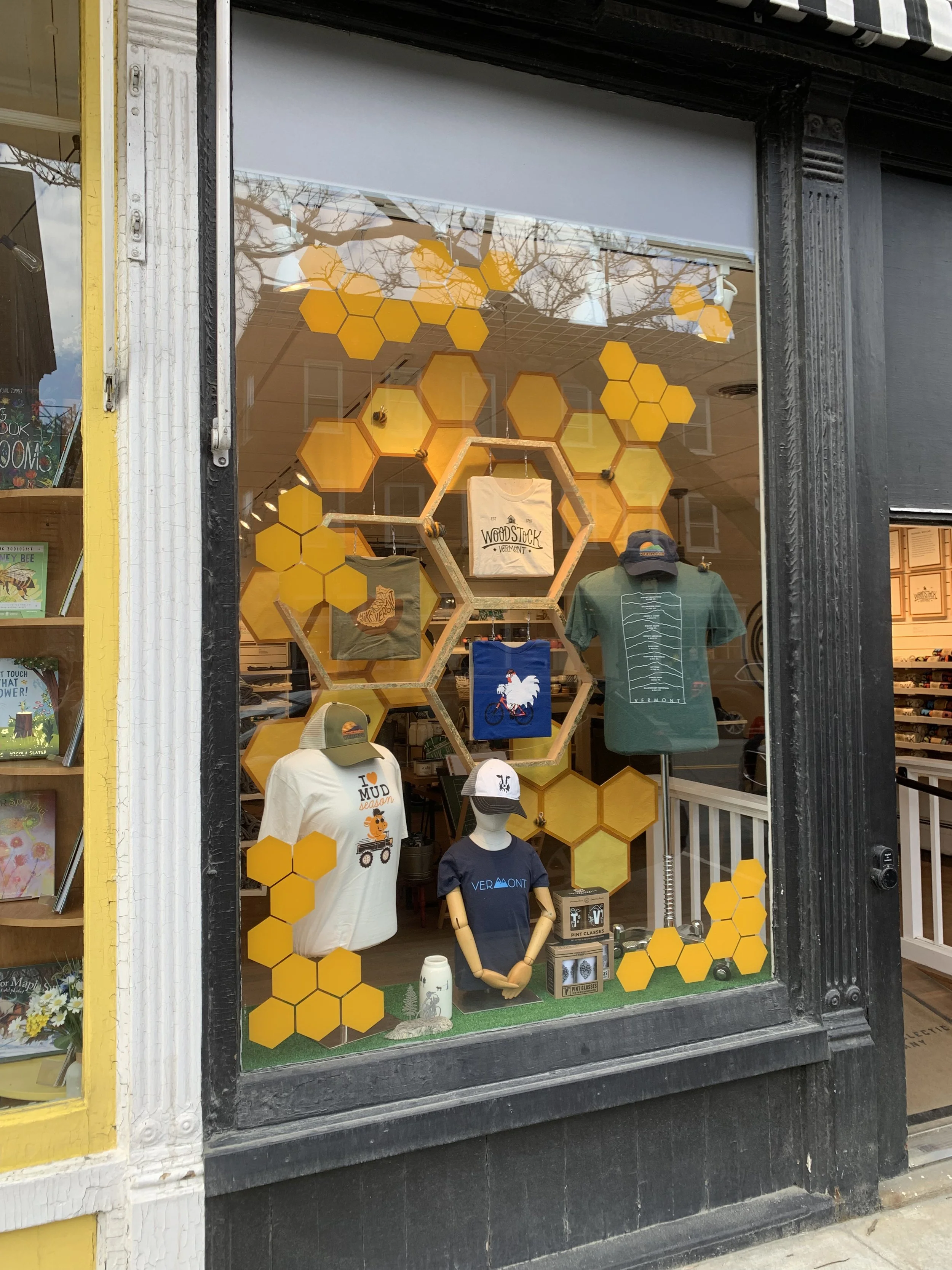 Detail of left honeycomb window featuring t-shirts showcasing depth of display