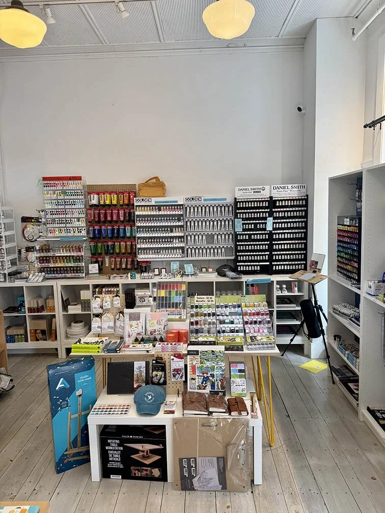 Watercolor wall and nesting tables with product merchandised on them - June refresh 2025