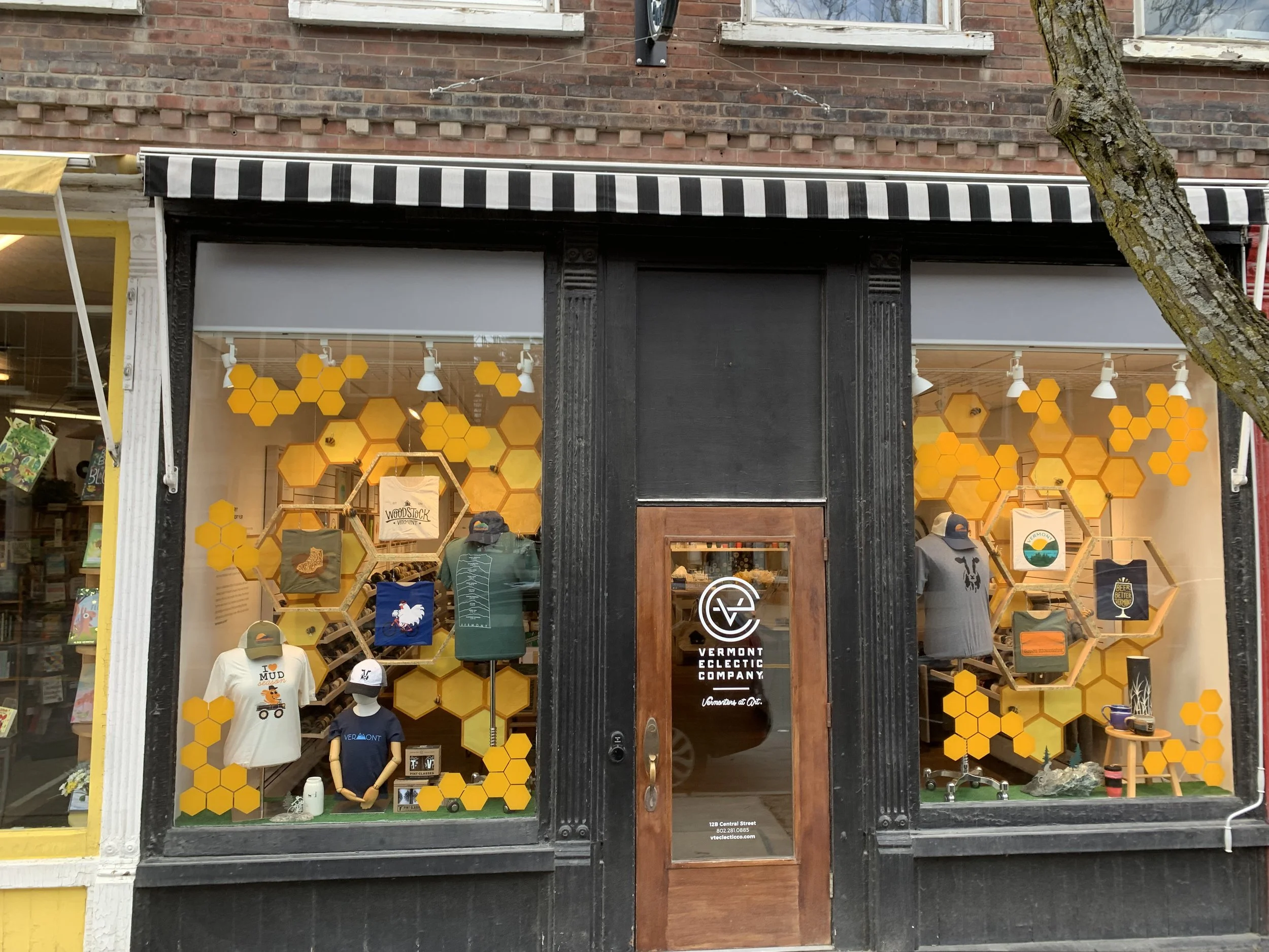 Storefront windows with layered honeycomb display showcasing t-shirts