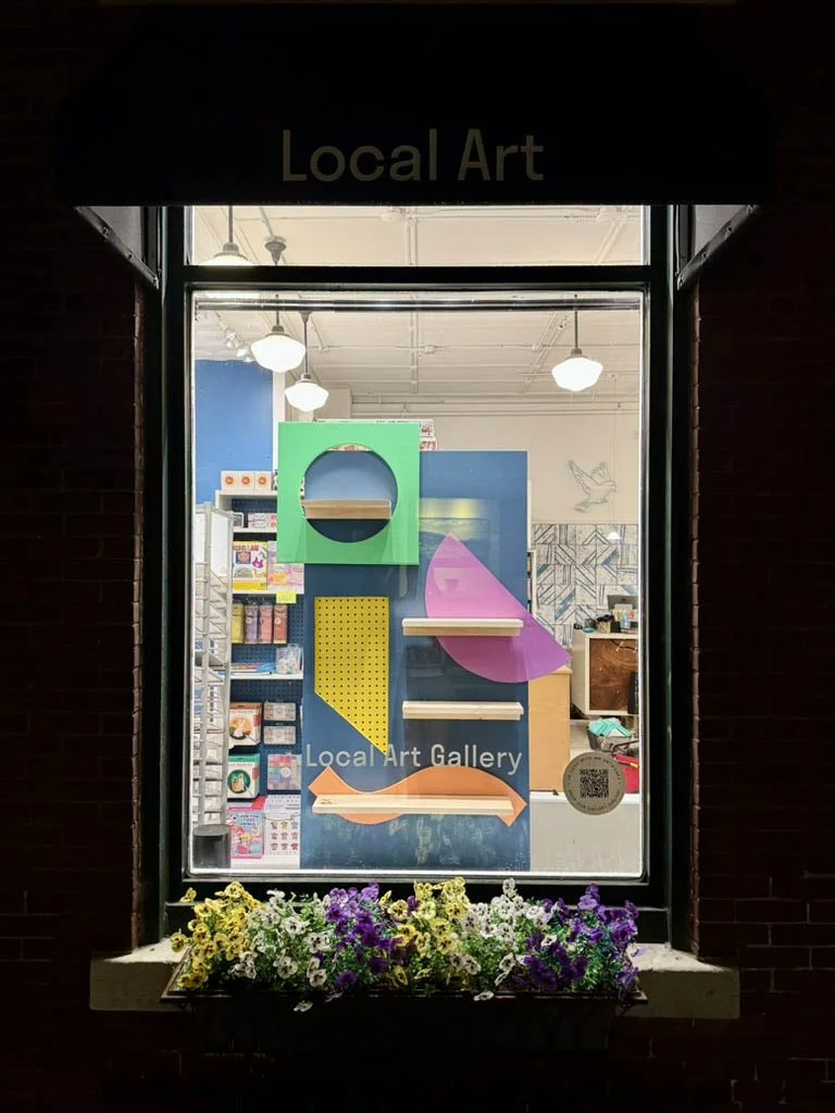 Left window display of colorful shapes and shelves, no product - June refresh 2025