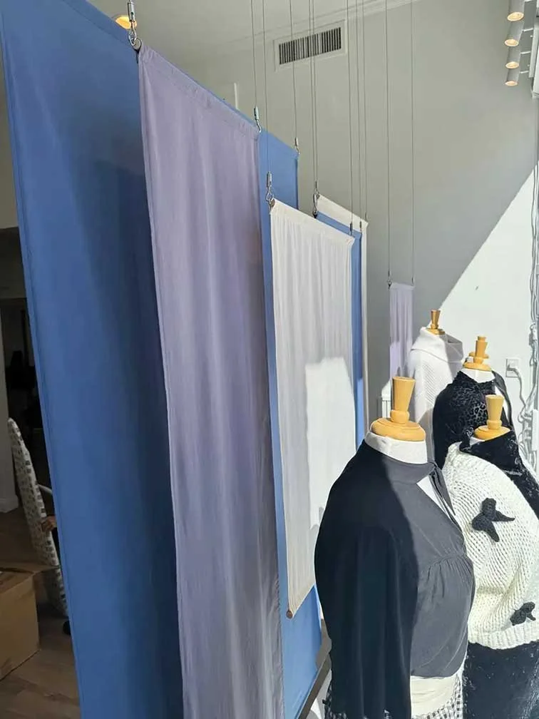 Closeup view of mannequins and fabric panels